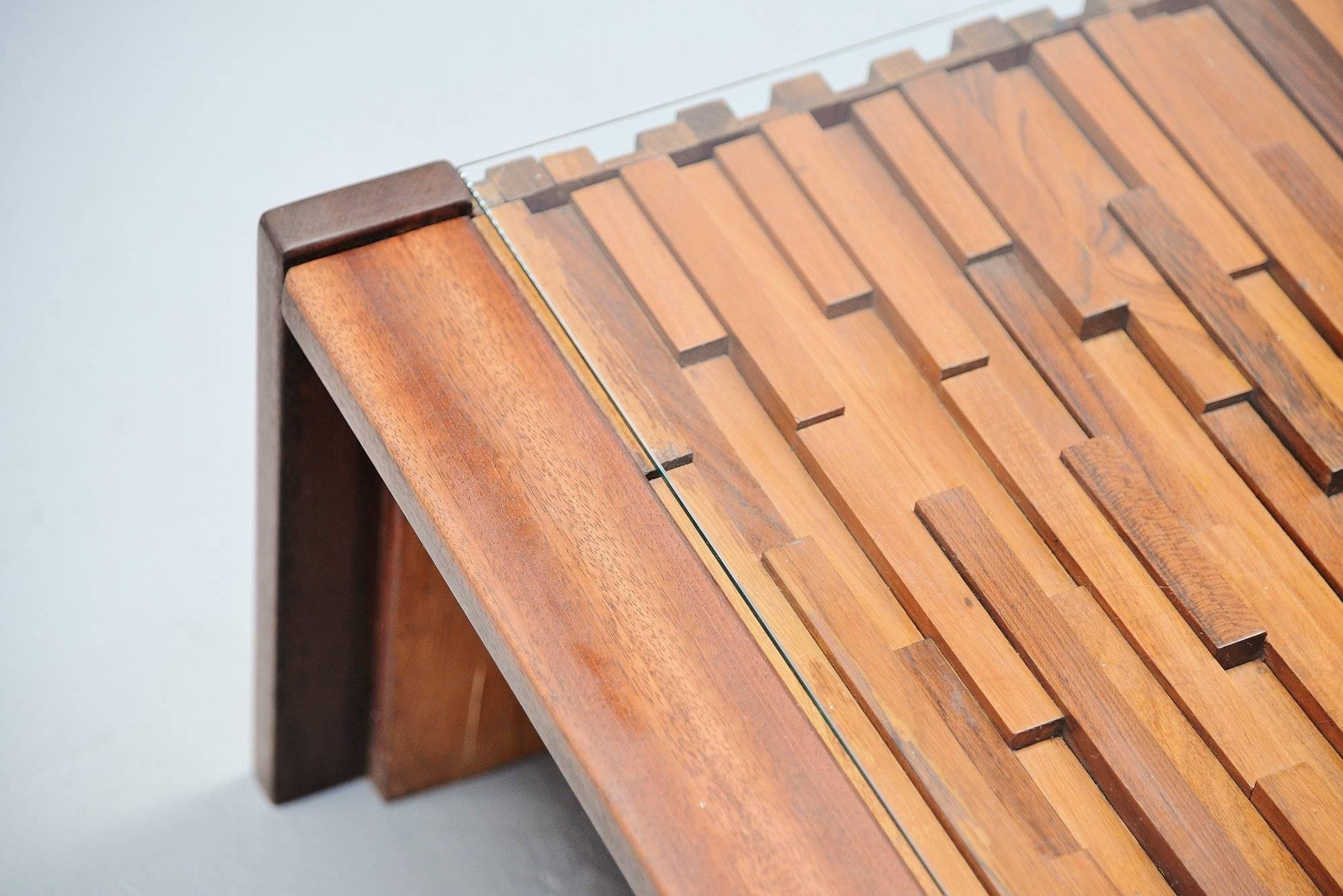 Very nice sculptural coffee table designed and manufactured by Percival Lafer, Brazil 1960. The table was made of several wooden parts including rosewood, teak and jacaranda. The top is finished with glass to protect the wood from dirt and damages.