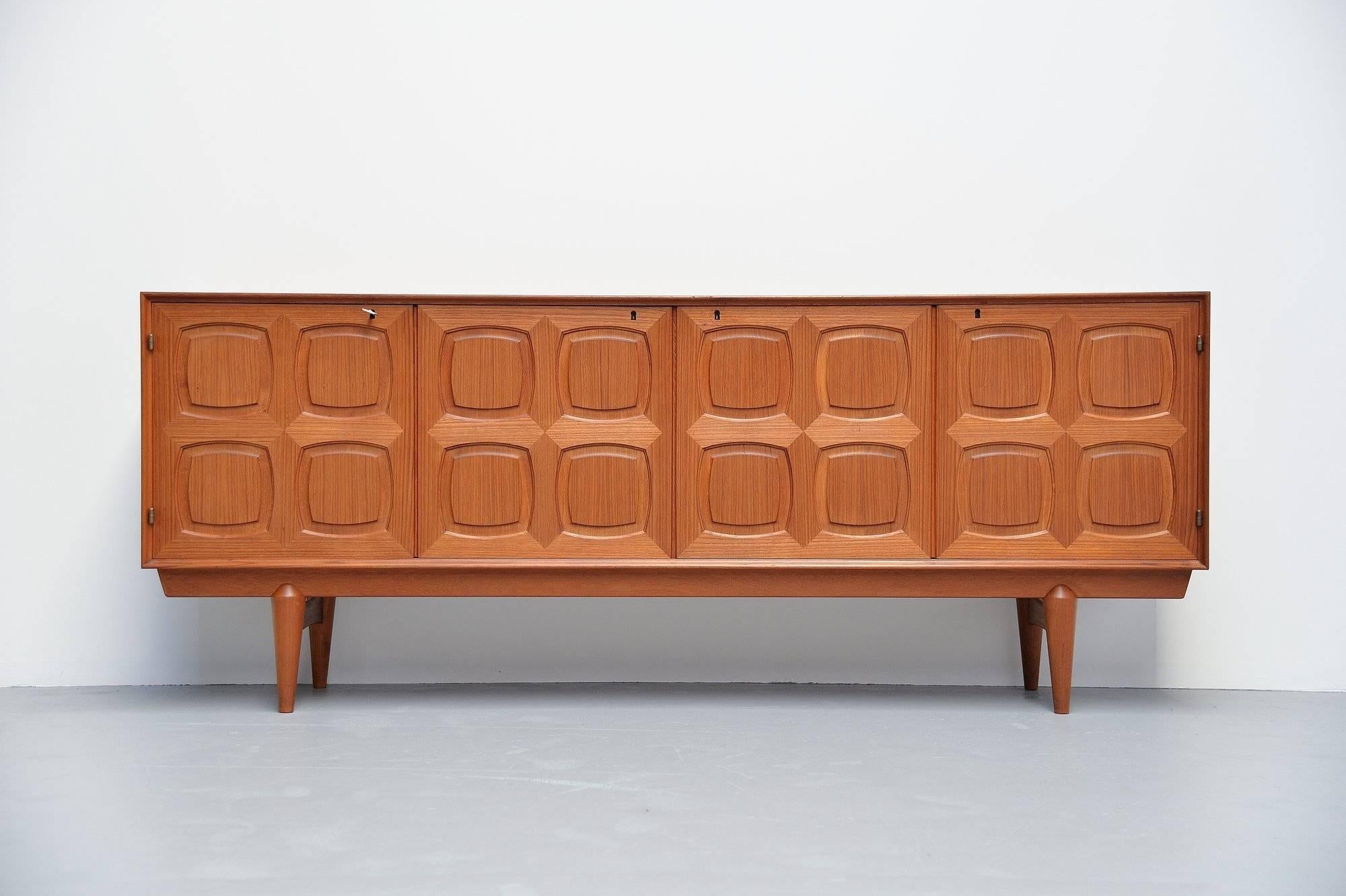 Nice graphic sideboard designed by Rastad & Relling and manufactured by Gustav Bahus, Denmark, 1960. The sideboard is made of teak wood and has very nice graphic panel doors. Four Doors with shelves behind and sliding shelves behind the right door.