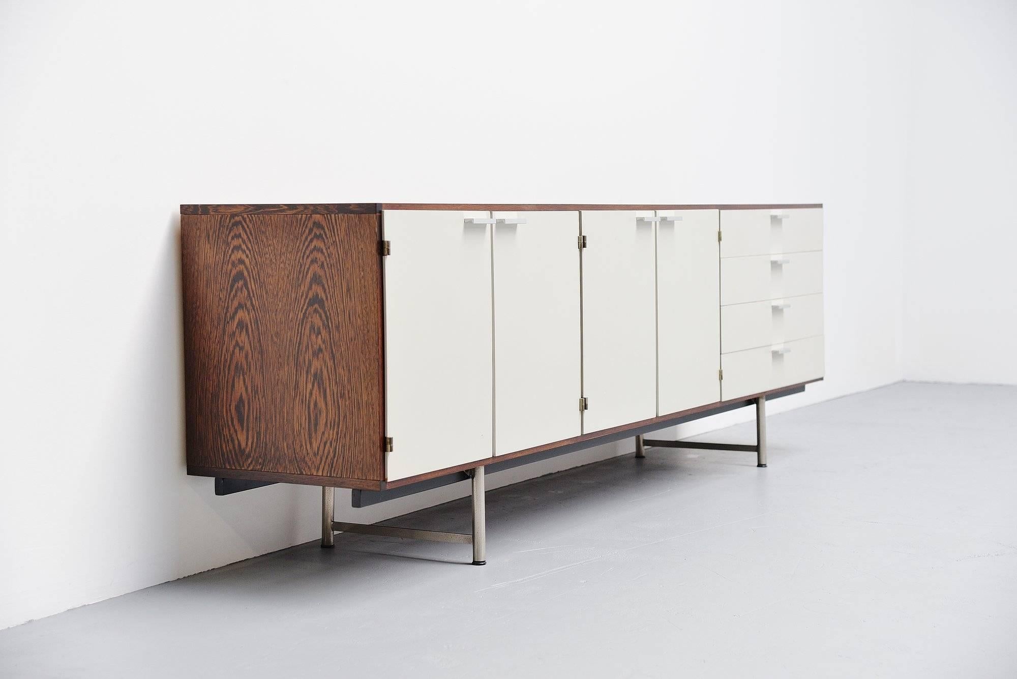 Very nice modernist sideboard designed by Cees Braakman, manufactured by Pastoe UMS Holland 1960. This is for a sideboard with a wenge cabinet and white painted doors. The sideboard has aluminum grips and matt chrome plated legs. It has 4 folding