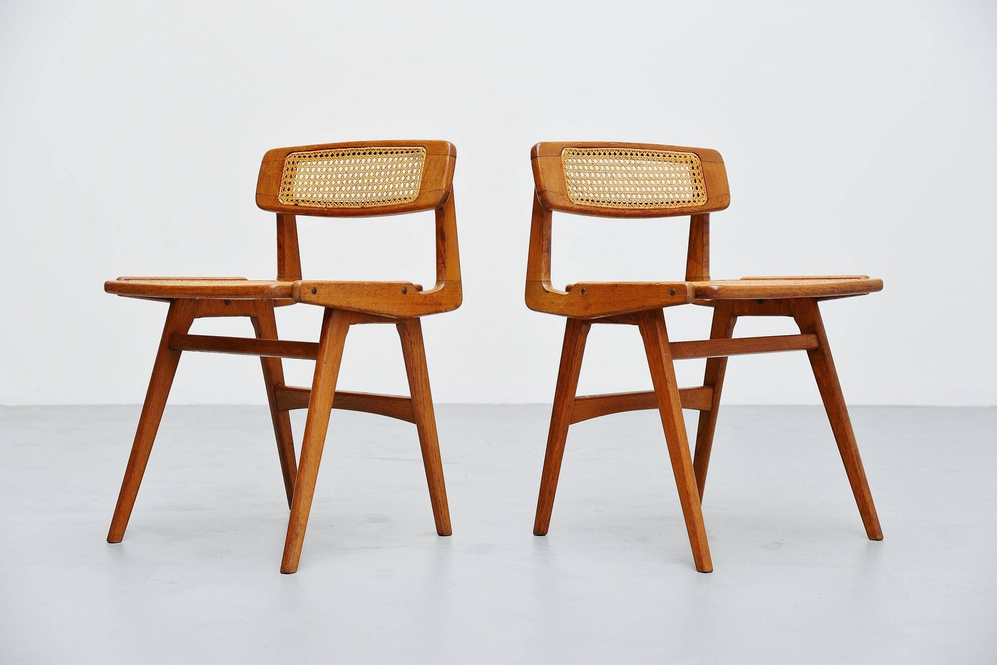 Pair of forme libre side chairs designed and manufactured by Roger Landault, France 1952. These chairs are made of solid oak and have a cane woven seat and back. The chairs are close to several designs by Charlotte Perriand and Pierre Chapo. They