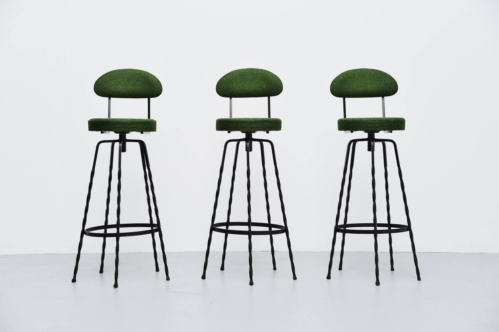 Very nice set of three bar stools in wrought iron, in the style of Mathie Mategot but made by unknown manufacturer or designer. The stools has black painted wrought iron twisted frames which look very nice. We have newly upholstered the chairs in