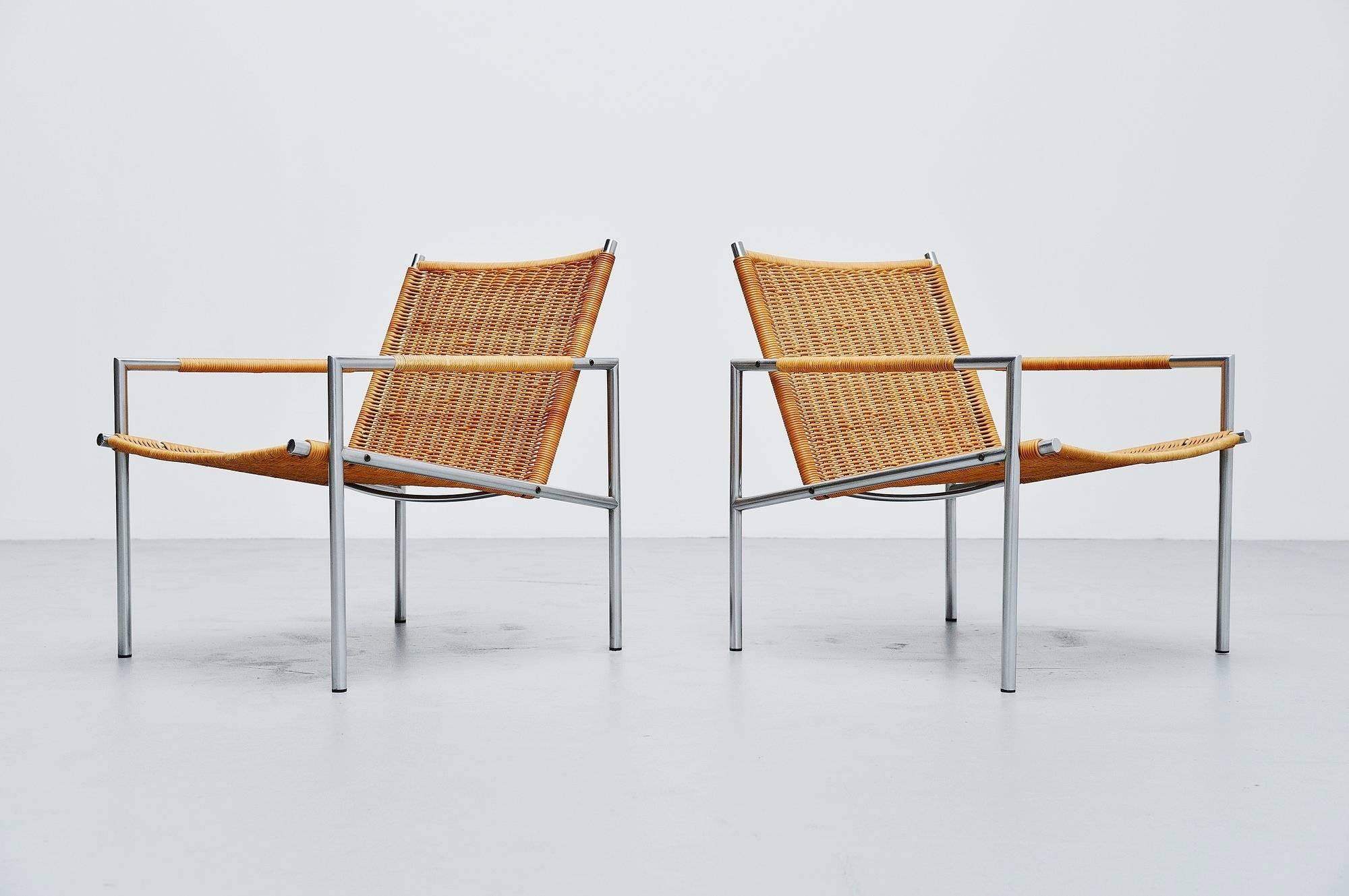 Modernist pair of lounge chairs model SZ01 designed by Martin Visser for 't Spectrum, Holland 1965. These chairs have a brushed steel tubular frame and very nice woven cane seats and arm rests finishing.. The cane has a nice patina from usage but is