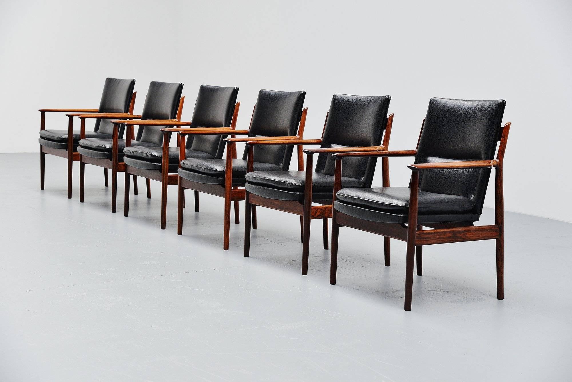 Fantastic conference chairs designed by Arne Vodder and manufactured by Sibast Mobler, Denmark 1960. The chairs have a solid rosewood frame and black leather upholstery. These chairs are hard to find in a set of six. Comfortable conference chairs in