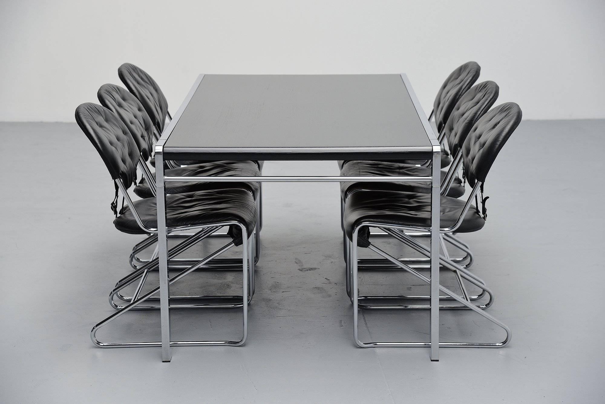 Elegant and timeless dining table model TE21/Anvers, designed by Claire Bataille and Paul Ibens, manufactured by 't Spectrum Bergeijk, Holland, 1971. The table has a polished aluminum frame and a black painted wooden top. The table can use up to six