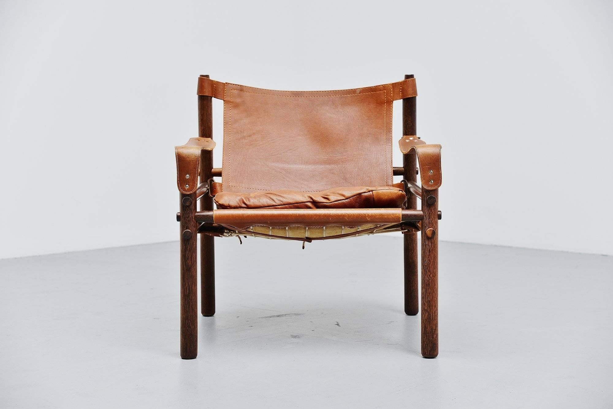 This is for an amazing cognac lounge chair designed by Arne Norell for Norell Mobler AB, Sweden 1964. This version has a solid rosewood frame and a fantastic cognac seat with wonderful patina from age and usage. I have rarely seen them in this nice