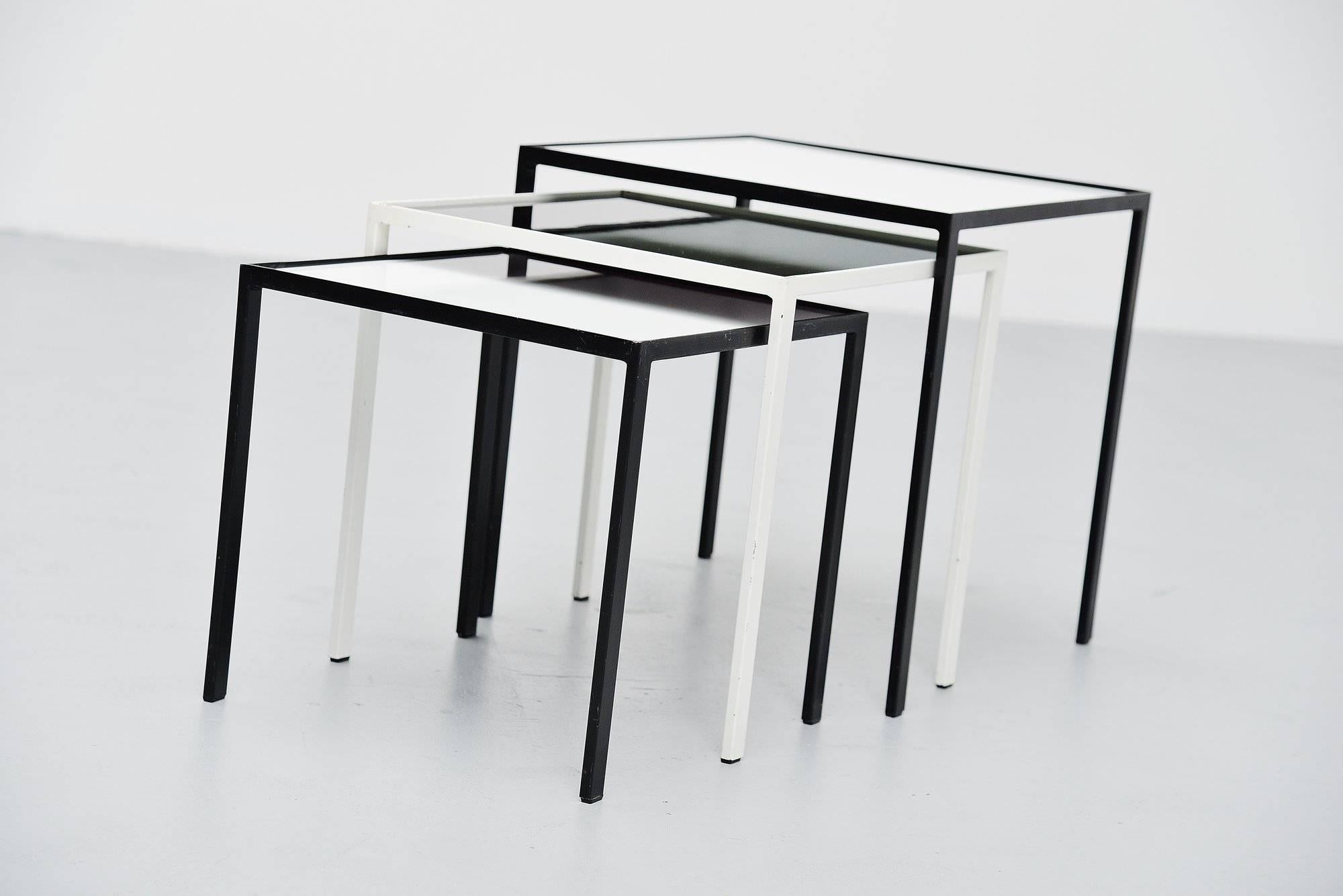 Very nice set of nesting table designed by Floris Fiedeldij and manufactured by Artimeta Soest, Holland, 1960. The tables have black and white painted metal frames and black and white glass tops. The glass tops have minor wear from age and usage but