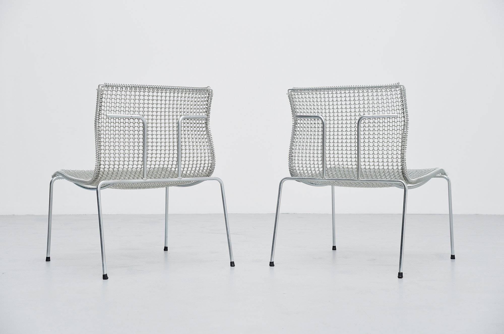 Nice pair of timeless easy chairs designed by Niall O'Flynn for 't Spectrum in 1997. These chairs were in production for only 4 years. Fantastic shaped chairs, made of galvanized metal. The chairs do not look really comfortable but they surprisingly