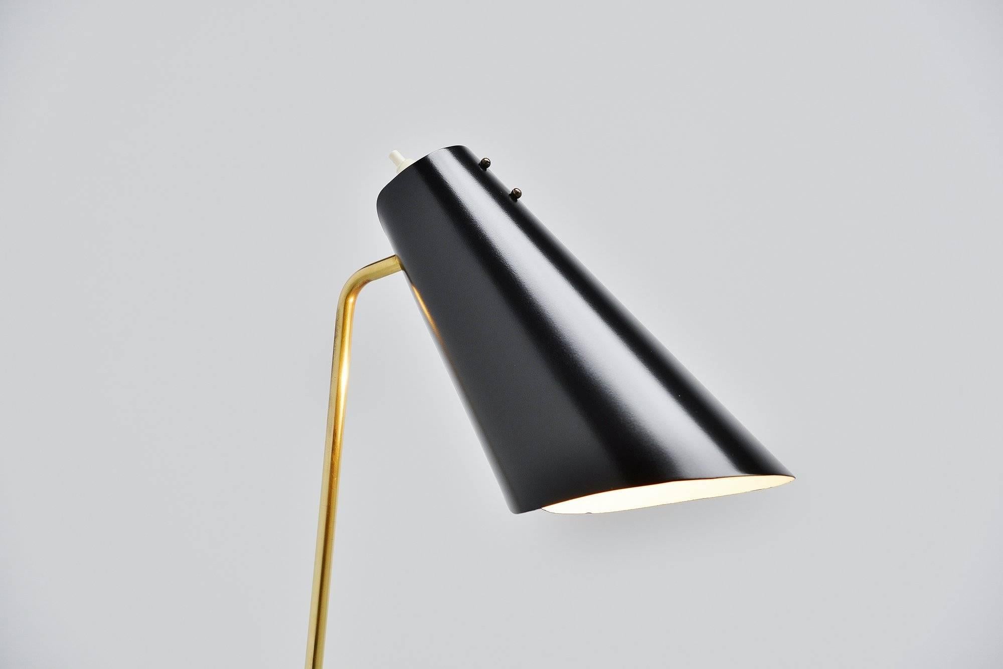 Nice small reading floor lamp designed and manufactured by ASEA Belysning, Sweden 1960. This floor lamp has a black lacquered weighted base and a brass arm. Adjustable black lacquered shade, refinished so in perfect condition. The lamp gives very