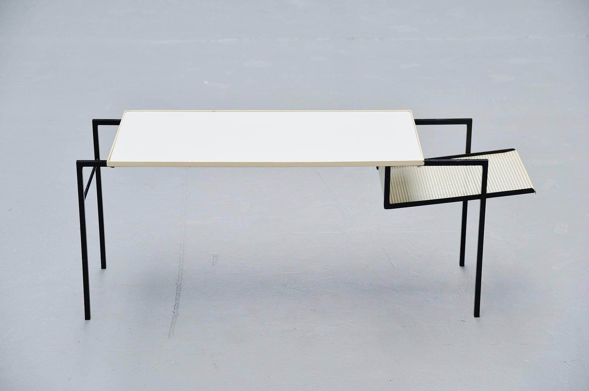Super rare side or magazine table designed by Floris Fiedeldij for Artimeta Soest, Holland 1955. This rare table has a solid steel frame, black lacquered. A white glass top and a die cut magazine rack. The table is in original condition. A fantastic