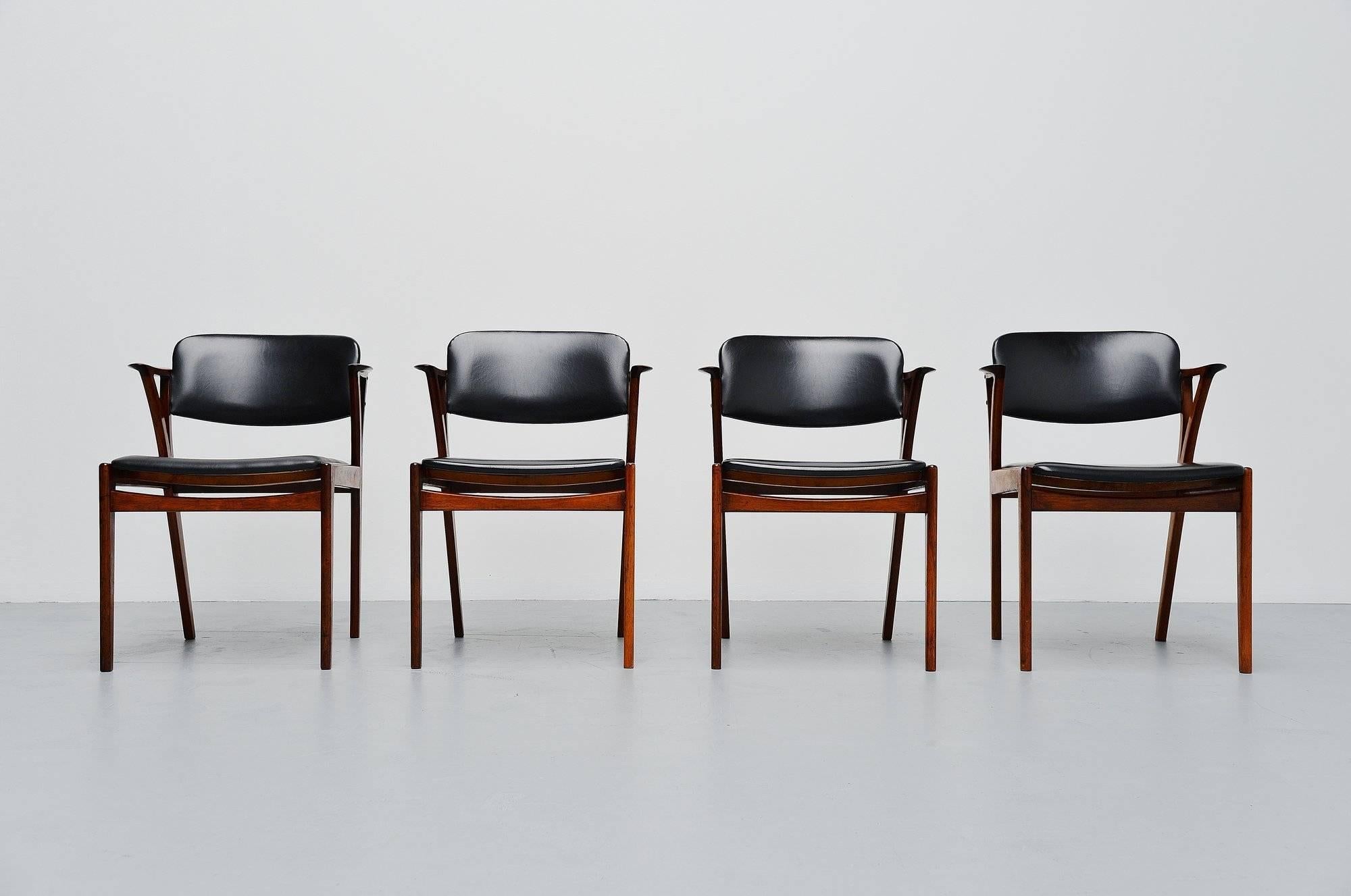 Very nice set of four-arm chairs designed by Kai Kristiansen and manufactured by Bovenkamp furniture, Holland 1960. The chairs have a solid rosewood frame and black faux leather upholstery. The chairs have a very nice and refined shape, the short