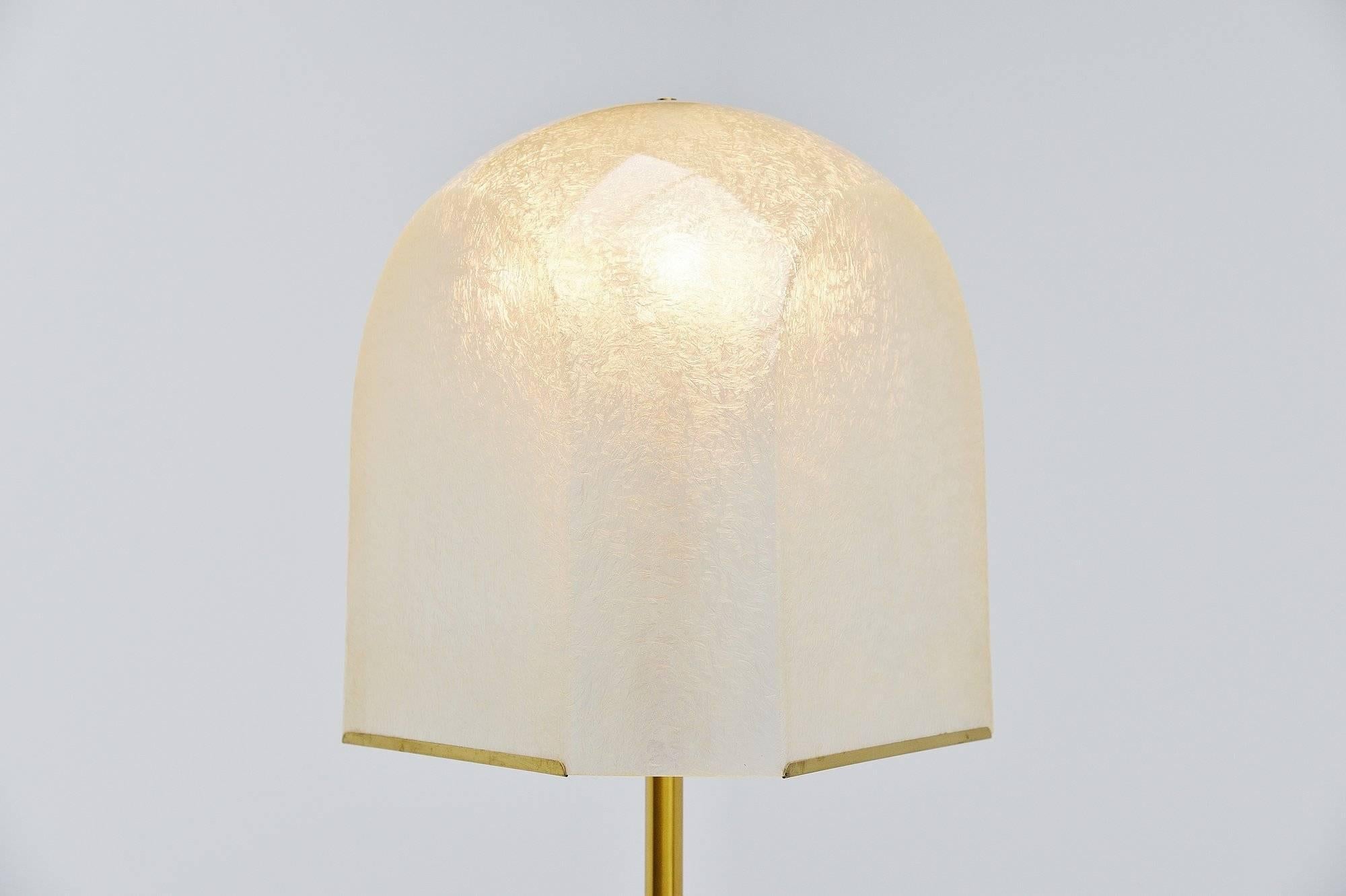 Large impressive floor lamp designed by Salvatore Gregorietti and manufactured by Lamperti, Italy 1960. This lamp has a nice fiberglass shade and a brass stem with a weighted travertine base. The lamp gives very nice and warm light when lit and uses