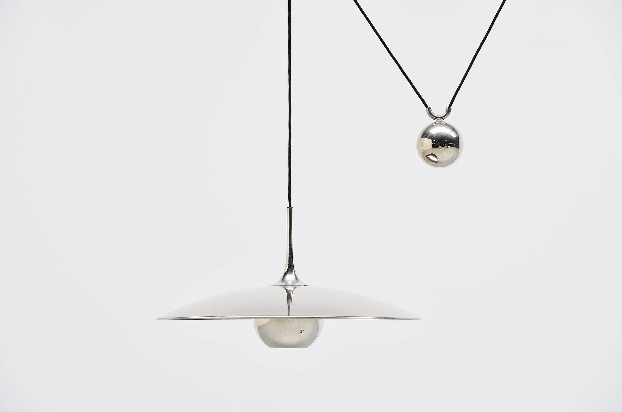 Fantastic adjustable ceiling pendant lamp model Onos 55 designed by Florian Schulz, Germany, 1970. This lamp is made of chrome-plated metal and has a weighted ball to adjust the height on the shade, you can also choose how wide you want to hang it