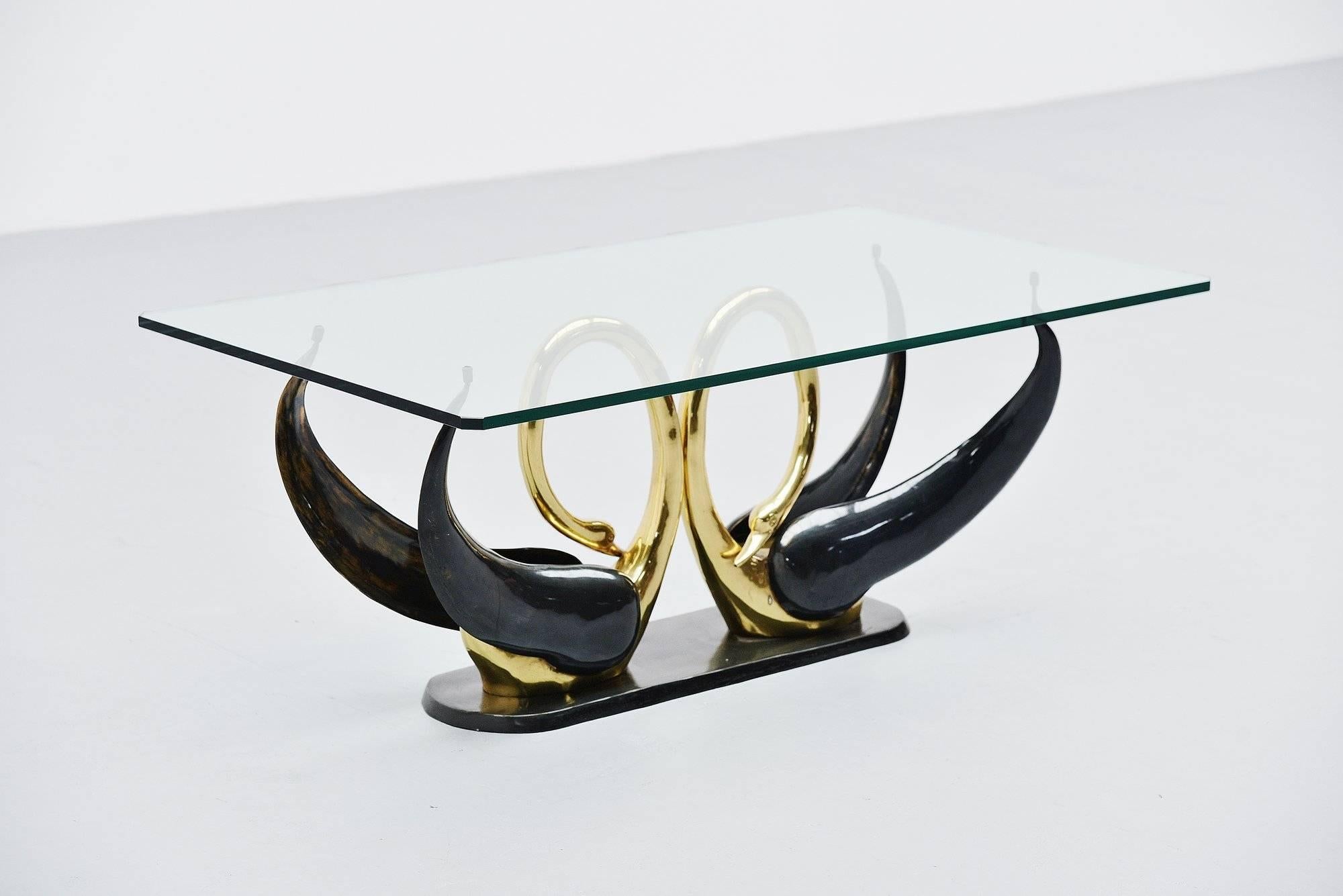 Very nice swan shaped coffee table attributed to Maison Jansen, France, 1970. This table has an elegant swan shaped base made of solid bronze, partly black patinated. The base supports a rectangular glass top with cut edges, thick hardened glass.