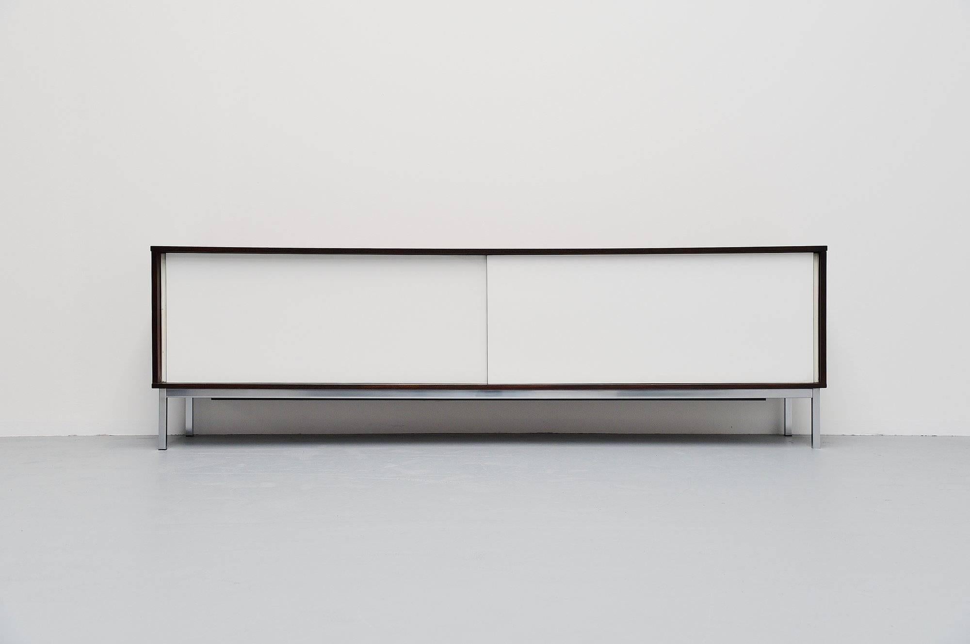 This is for a fantastic modernist sideboard designed by Martin Visser for ‘t Spectrum Bergeijk, produced between 1965 and 1971. This is the longest version of this sideboard at 236,5 cm. The sideboard is in wenge wood and has white laminated doors,