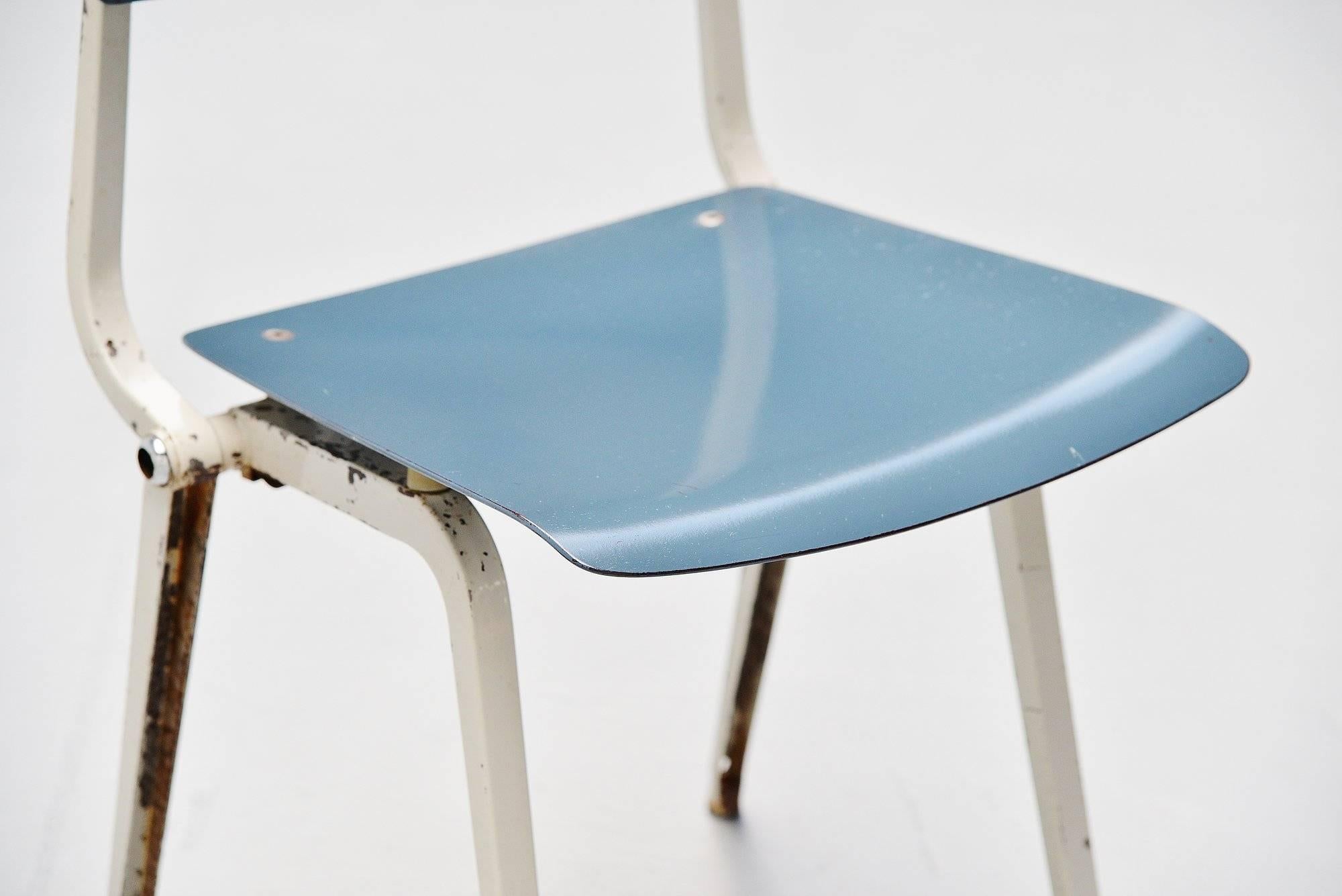 Rare Revolt folding chair designed by Friso Kramer for Ahrend de Cirkel, Holland 1953. Though the Revolt chair was already designed in 1953, the production started in 1958. The chair has a folded metal base which was very strong and a blue ciranol