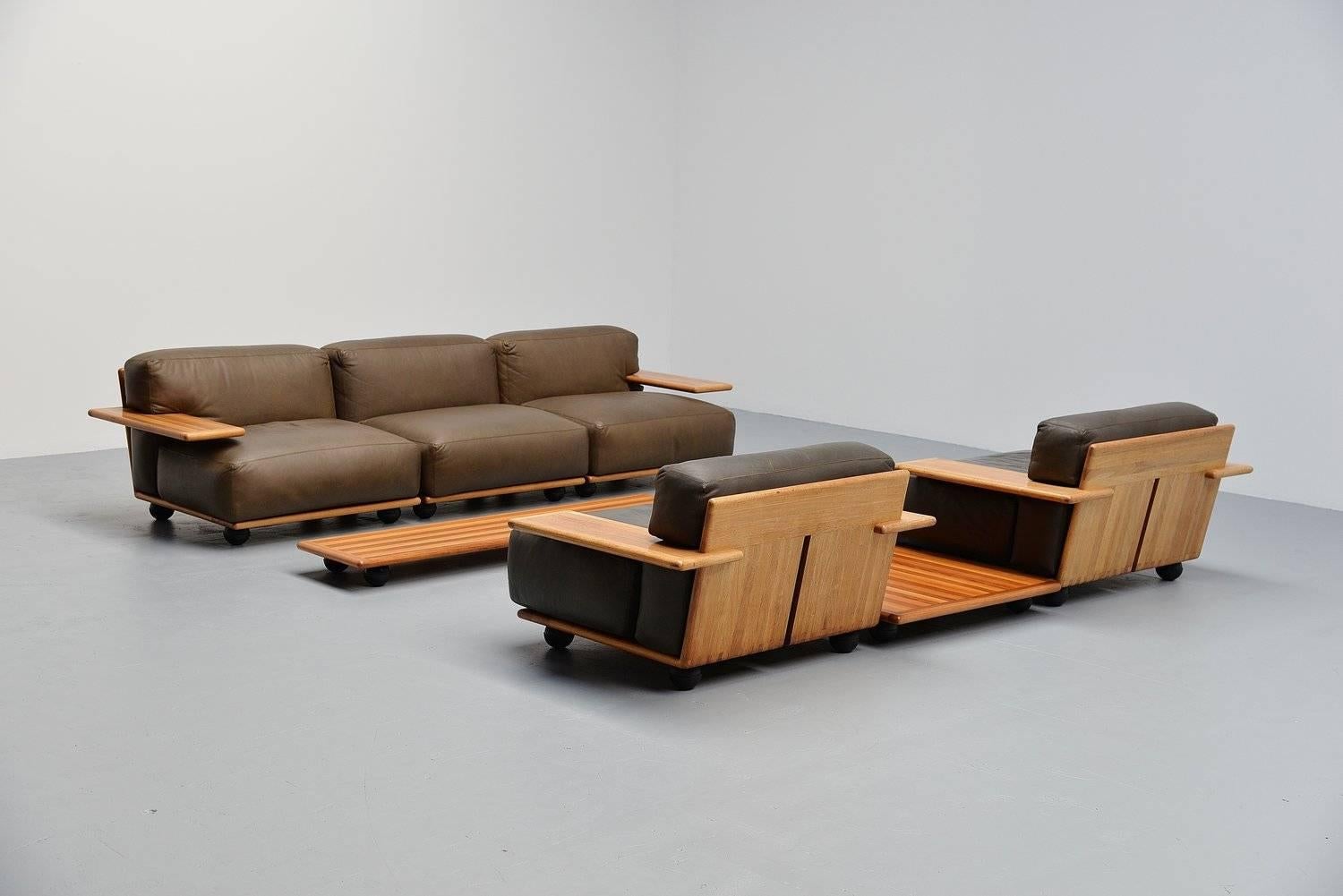 Fantastic complete seating group designed by Mario Bellini for Cassina, Italy 1971. This set was called Pianura and has a solid walnut wooden frame, or top. The cushions are made of dark olive green leather and has a very nice patina from age and