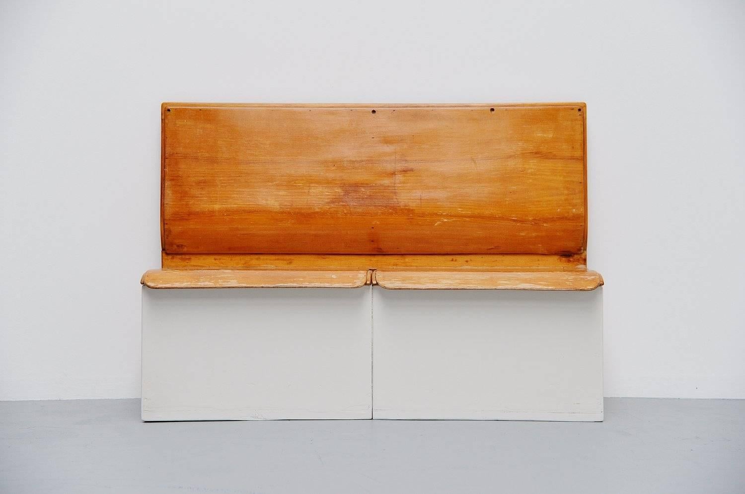 Fantastic rare laundry bench designed by Piet Zwart for Bruynzeel, Holland 1950. This bench was probably part from a kitchen/laundry unit designed by Piet Zwart in the 1950s. The bench has 2 folding seats where you could put laundry in. The inside