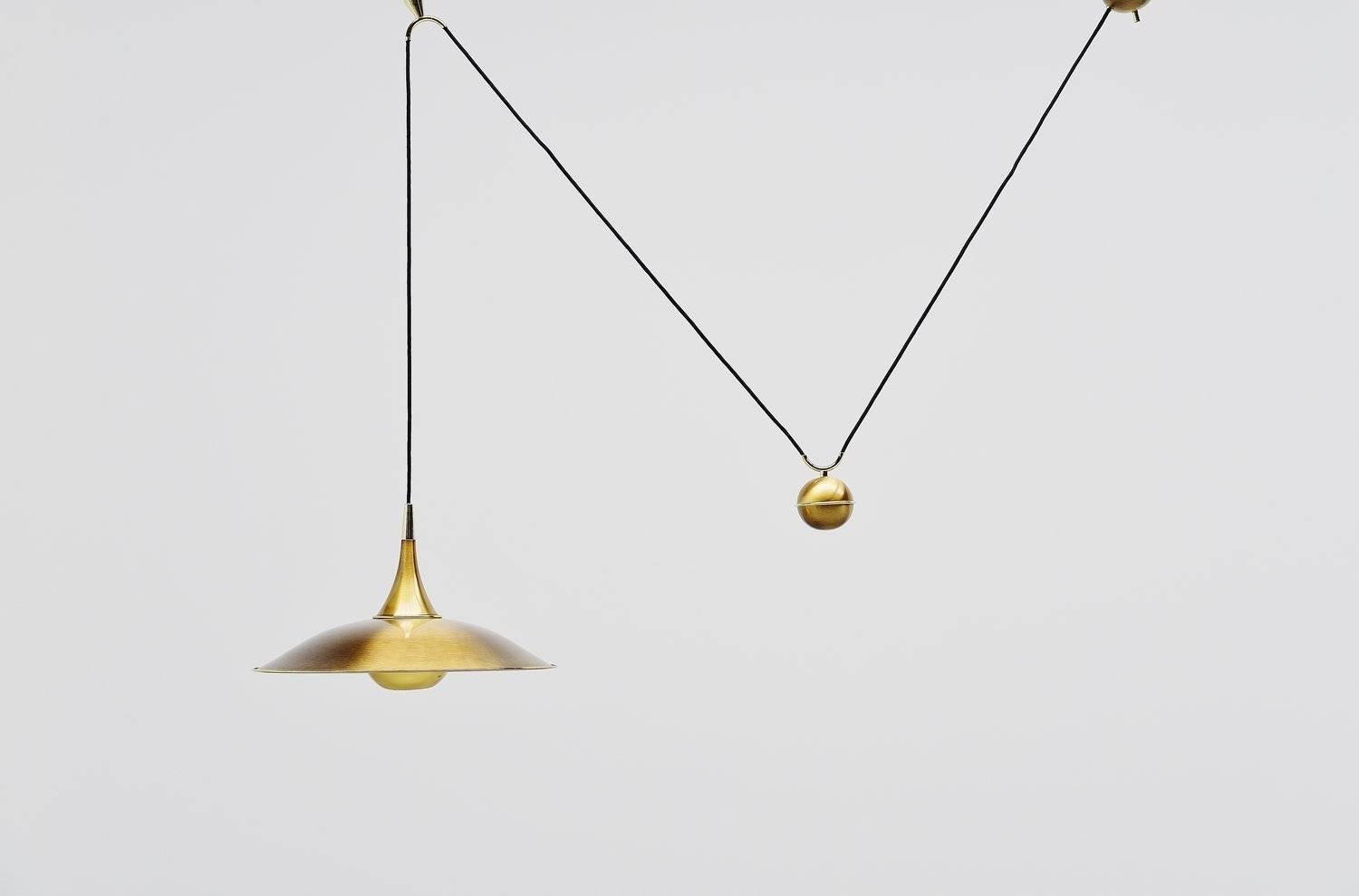 Very nice adjustable ceiling pendant designed by Florian Schulz, Germany, 1970. This lamp has a weighted ball to adjust the height on this (from 80 cm to 140 cm) and you can also choose how wide you want to hang it. It gives very nice diffused light