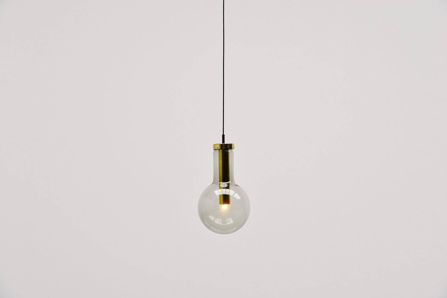 Very nice set of five pendant lamps designed and made by RAAK Amsterdam, Holland, 1965. These lamps are called maxi globes and this is the biggest version available. The lamps have grey fume glass and a brass fixture. They can be used as ceiling