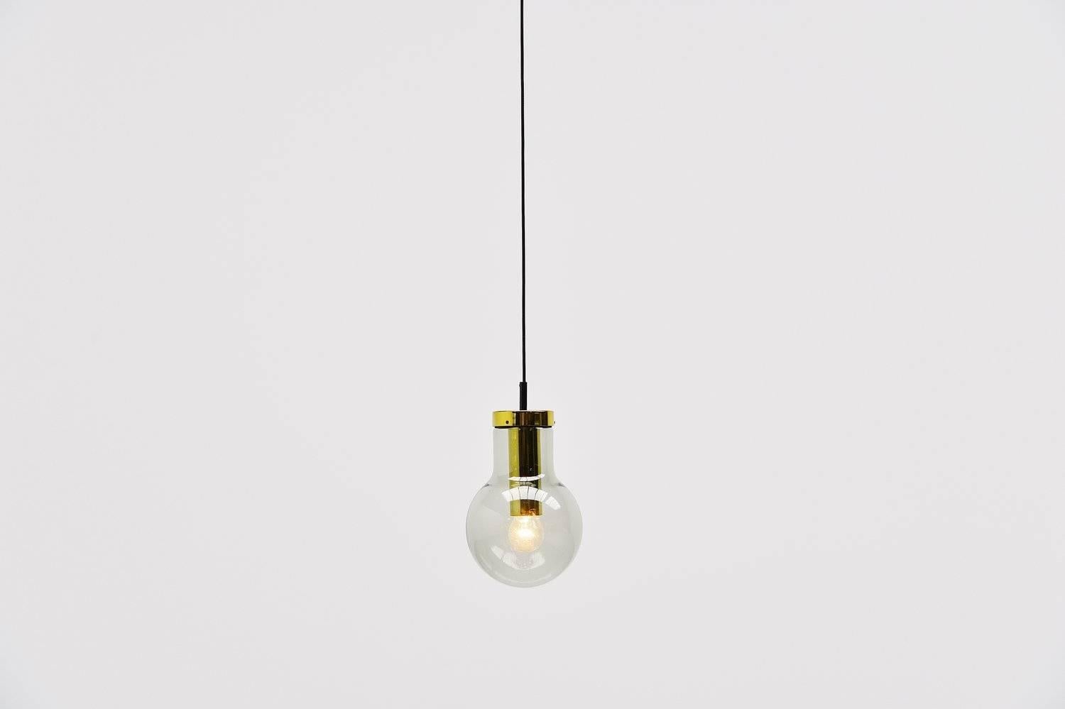 Very nice set of 4 pendant lamps designed and made by RAAK Amsterdam, Holland 1965. These lamps are called maxi globes and this is the smallest version available. The lamps have grey fume glass and a brass fixture. They can be used as ceiling lamp