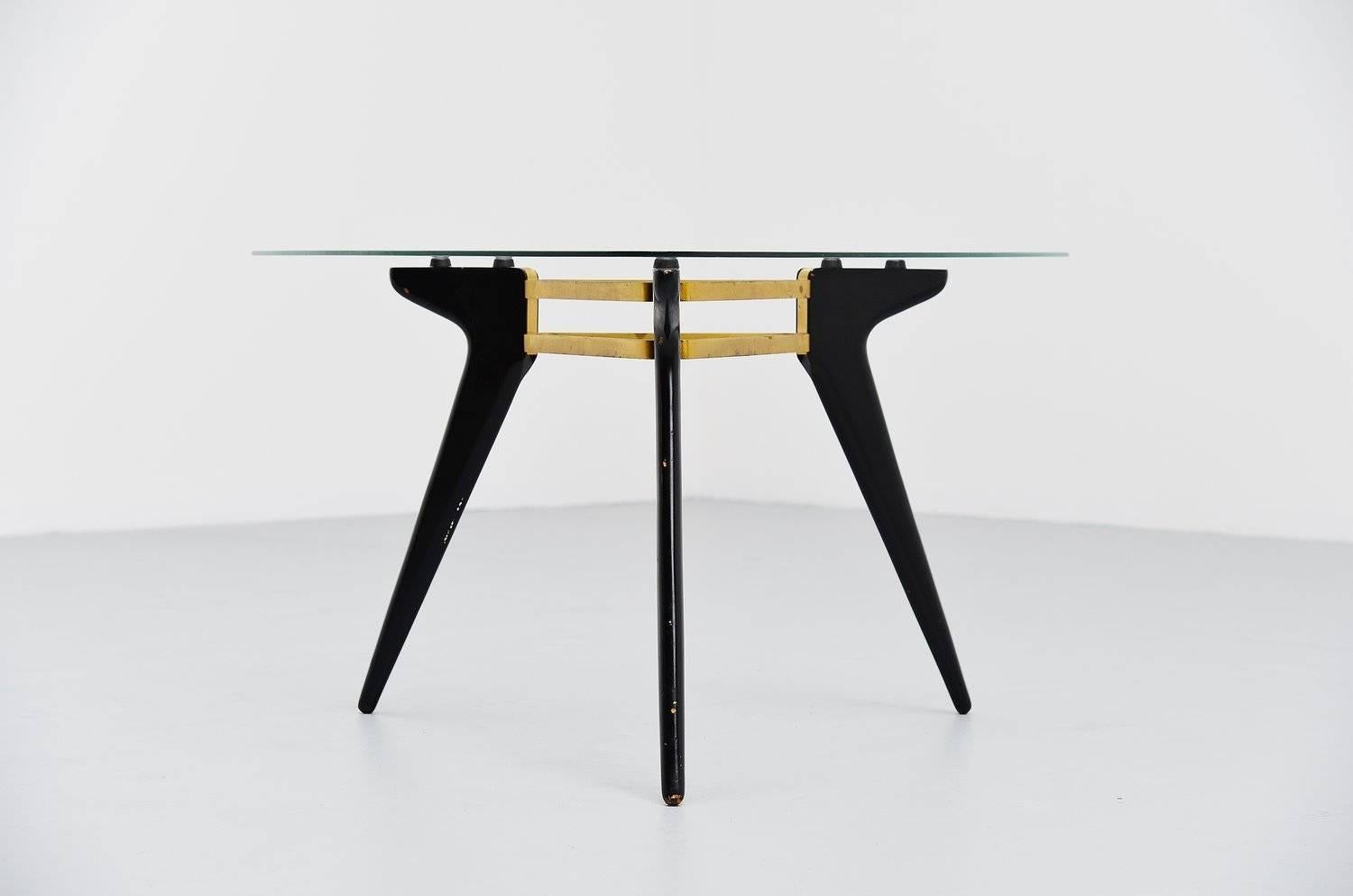 Very nice Belgian coffee table with black lacquered wooden legs, brass connected frame and a triangular glass top. This was from the end of the 1950s for sure but we don't know the manufacturer or designer. Probably from the 1958 Expo period, for