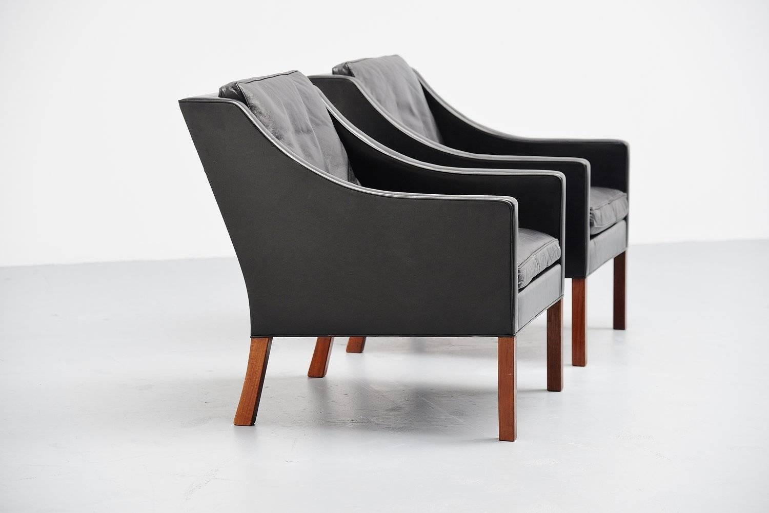 Excellent pair of lounge chairs designed by Borge Mogensen for Fredericia Stolefabrik, Denmark 1963. These chairs have high quality black leather upholstery and solid teak legs. The chairs are in very good original condition with very nice patina to