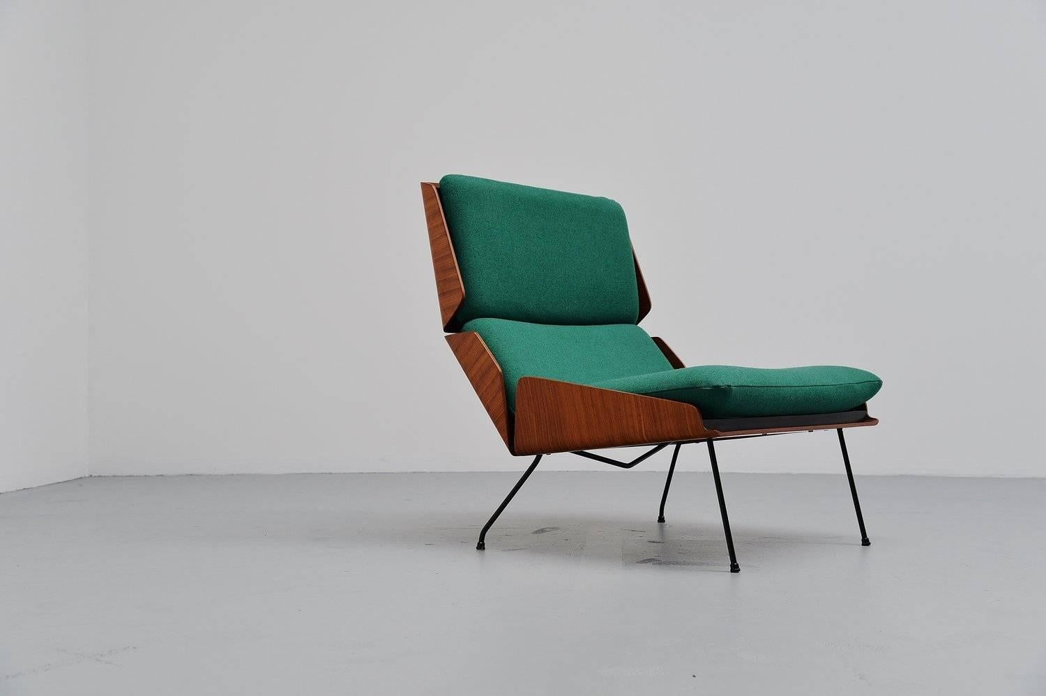 Amazing shaped lounge chair designed by Georges van Rijck for Beaufort, Belgium, 1959. This chair has a teak plywood frame existing in three parts. Attached to a solid black lacquered metal frame and it has new high quality upholstery (Tonica by