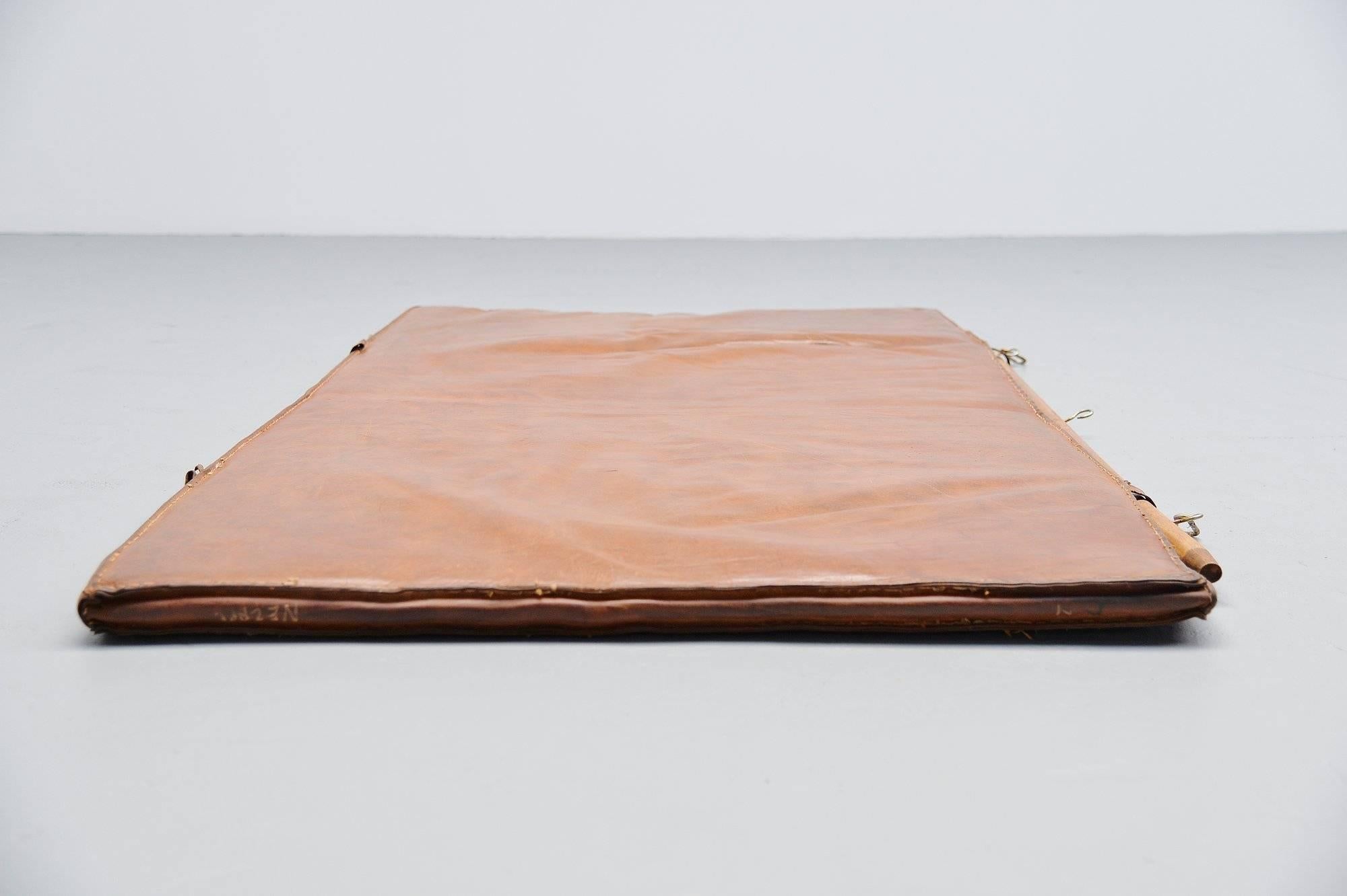 Highly decorative gymnastics mat made in Holland, 1960. This mat was made of cognac buffalo leather, stitched. This can also be wall hung using the wooden stick that was mounted (not original). Very nice an decorative piece of industrial design. In