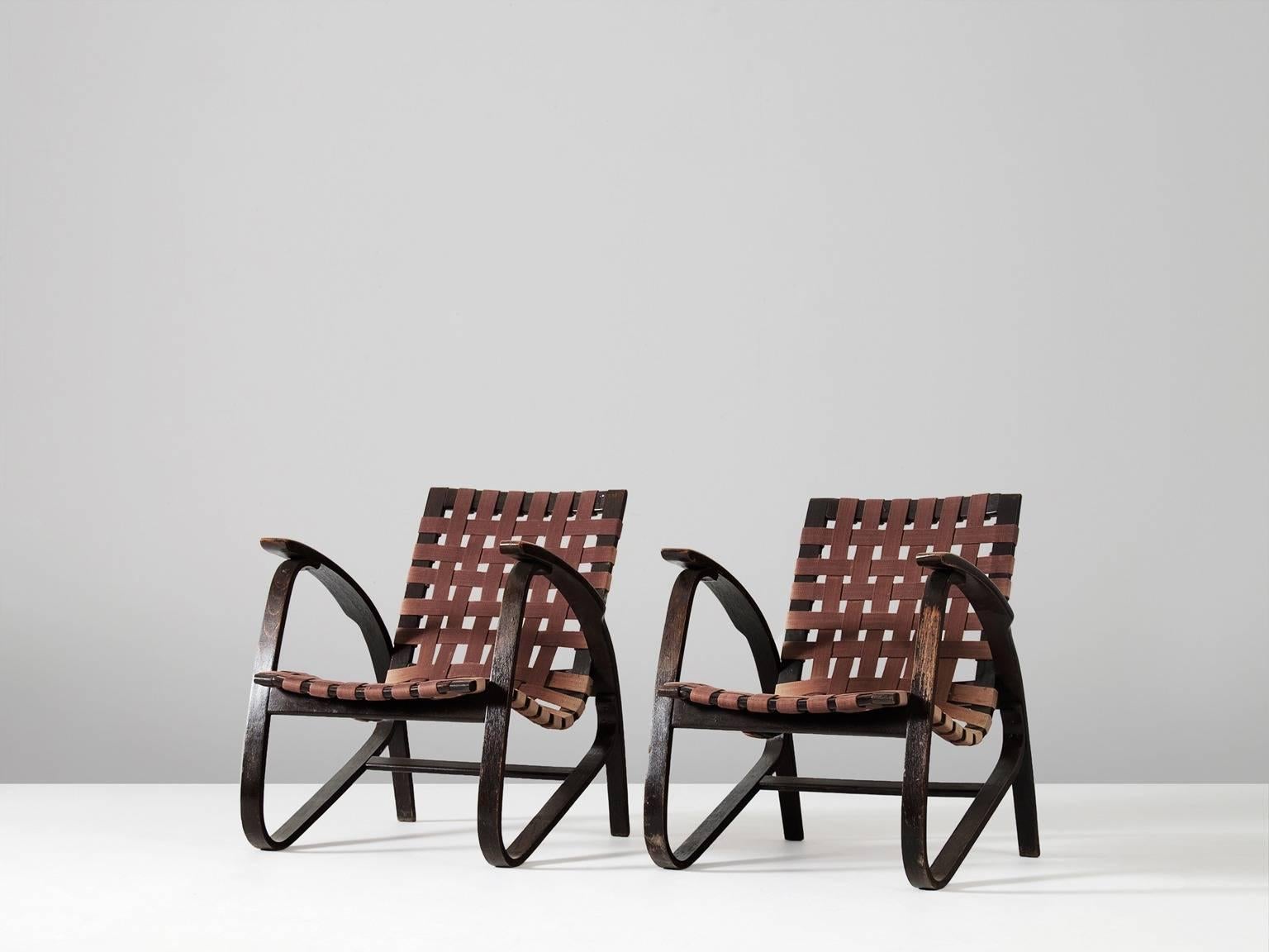Pair of lounge chairs, in wood and canvas, by Jan Vanek for UP Zavodny, Czech Republic 1930s.   

Stunning pair of dynamic armchairs designed by Czech architect Jan Vanek, who was a contemporary of Jindrich Halabala. These chairs are upholstered