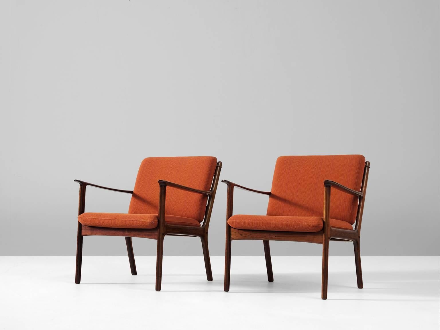 Pair of armchairs, in rosewood and fabric, by Ole Wanscher for P. Jeppesen Møbelfabrik, Denmark, 1951. 

Lounge chair model PJ 112 has an elegant solid rosewood frame, with nicely designed armrests and back. Due the slightly curves of the frame