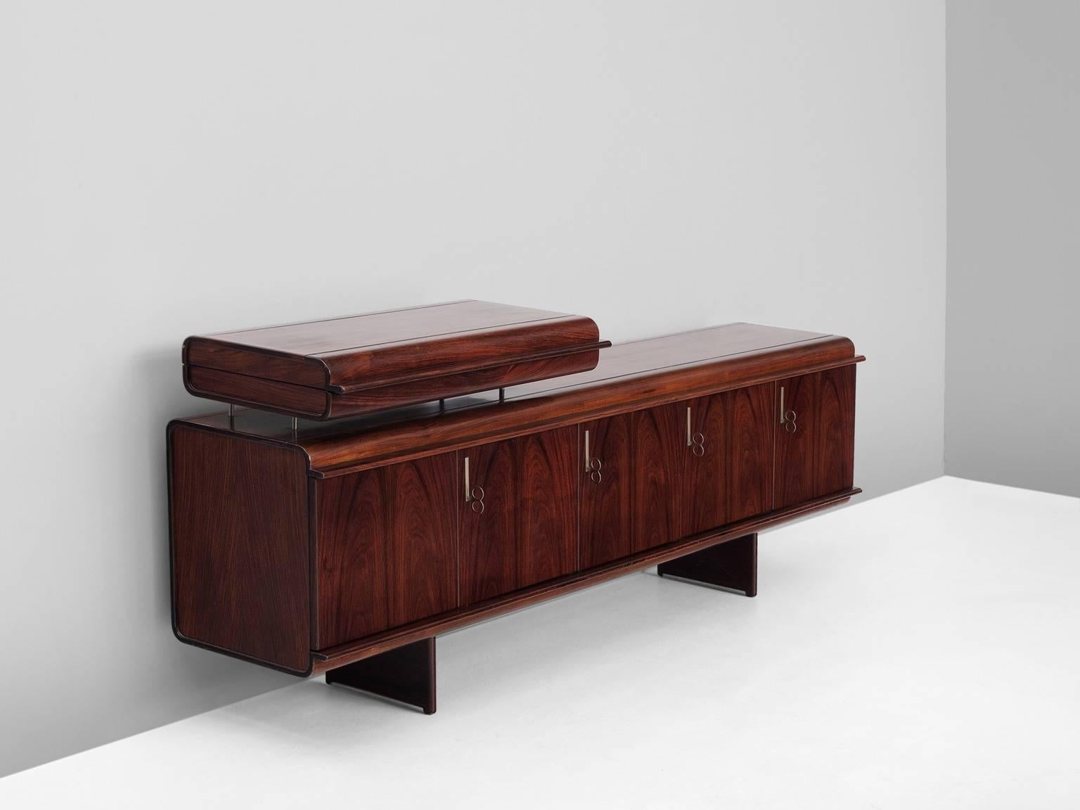 Sideboard, in rosewood, by Vittorio Introini for Sormani, Italy 1950s. 

Extraordinary credenza in rosewood veneer with additional cassette. Free-standing sideboard with rounded edges and veneered back. Four door sideboard, equipped with shelves