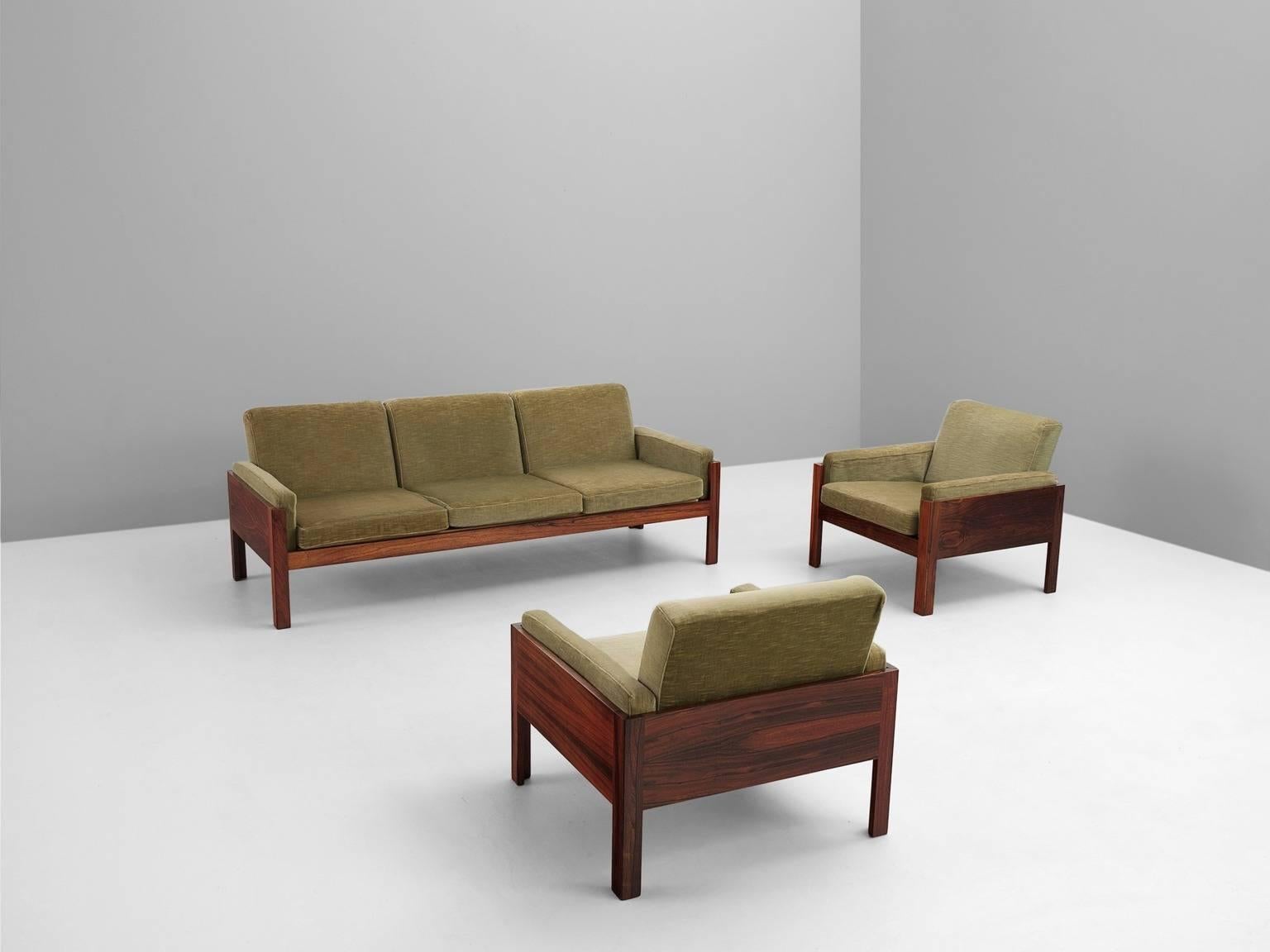 Salon set in rosewood and fabric, Scandinavia 1960s.

Salon set with three-seat sofa and two lounge chairs. This set has a cubic and modern design. The sofa and chairs get a more open character by the four legs. The grain of the rosewood is