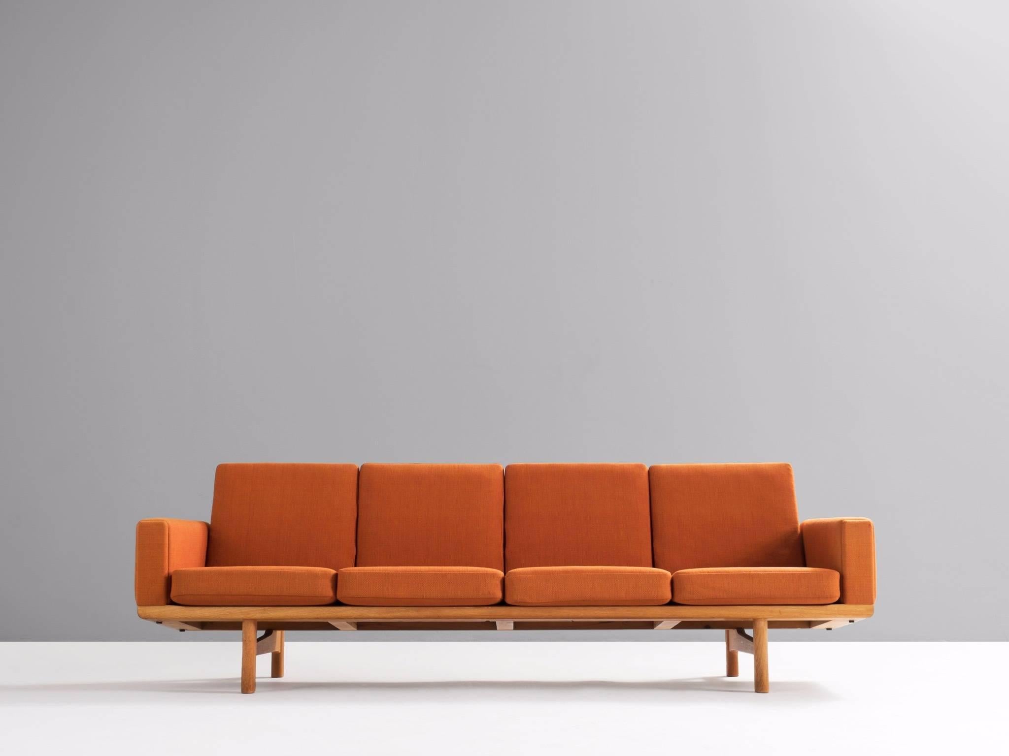 Sofa GE236/4, in oak and fabric, by Hans Wegner for GETAMA, Denmark, 1950s. 

Sofa designed by Hans Wegner for GETAMA. This sofa has a solid oak frame with real nice construction details. Due to the high legs and the low but detailed back, this