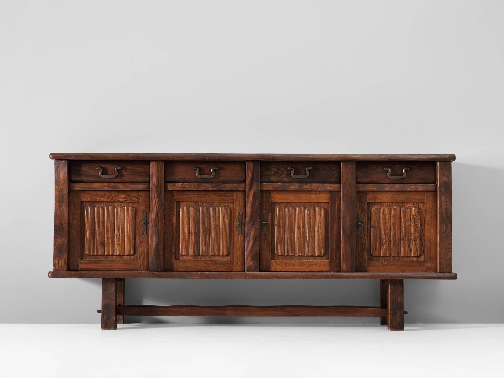 Sideboard in elm by Olavi Hanninen for Mikko Nupponnen, Finland, 1958. 

Large credenza in solid elm. This credenza has a simplified design with high attention to the natural look and grain of the wood. Four door sideboard with shelves and drawers.