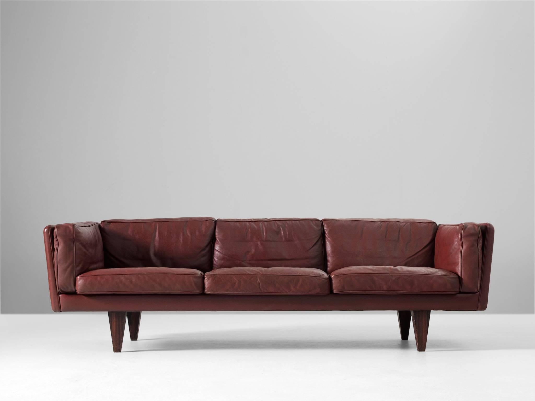 Sofa model V11, in leather and rosewood, by Illum Wikkelso, Denmark 1960s.

Stunningly three-seat sofa, designed by Danish designer Illum Wikkelsø. The original dark red high quality leather is in magnificent condition. This model is highly rare