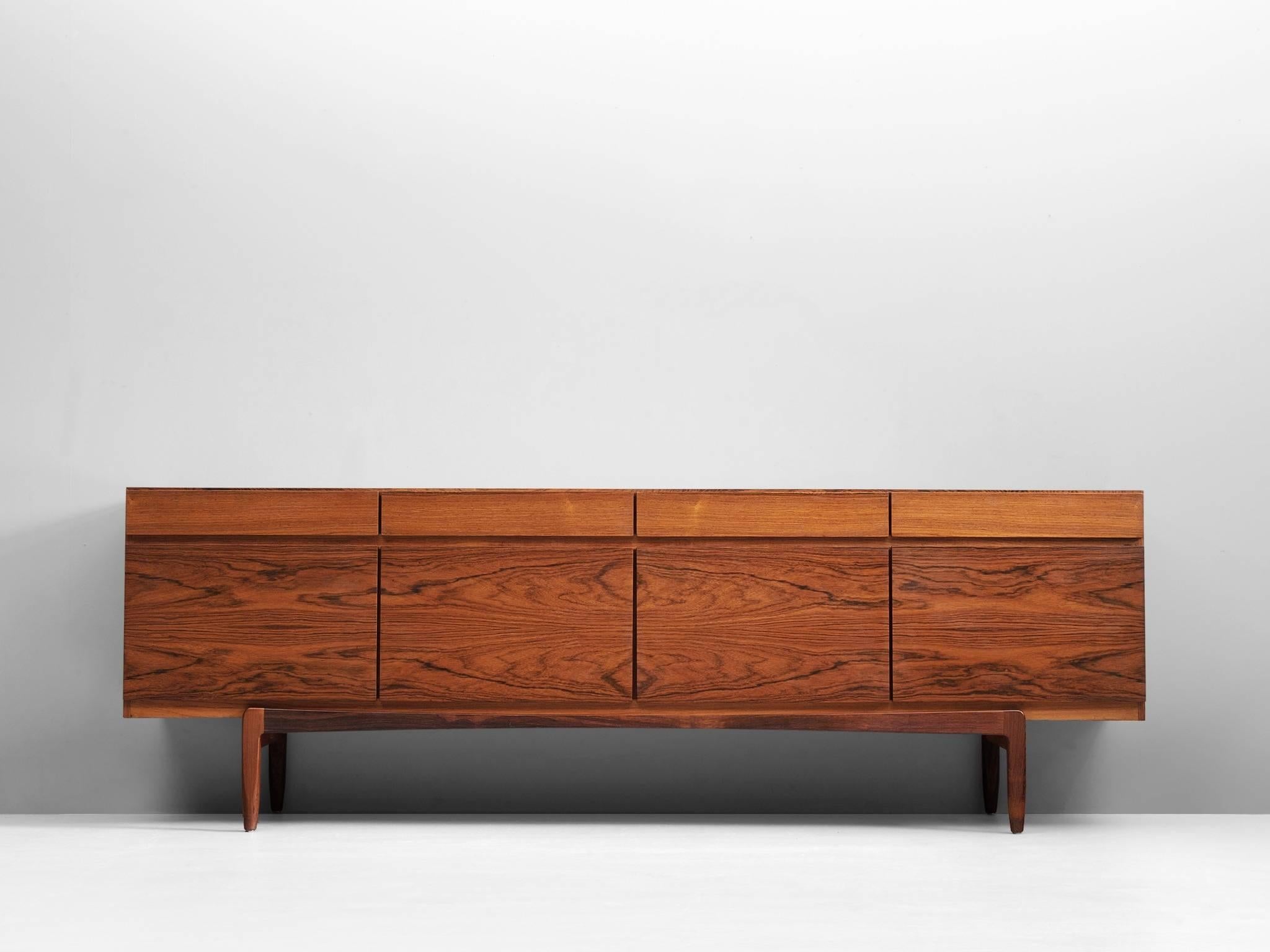 Sideboard model FA66, in rosewood by Ib Kofod-Larsen for Faarup Møbelfabrik, Denmark, 1960s. 

Excellent designed rosewood credenza by Ib Kofod-Larsen. The sideboard contains four doors with four drawers directly above it. The inside contains