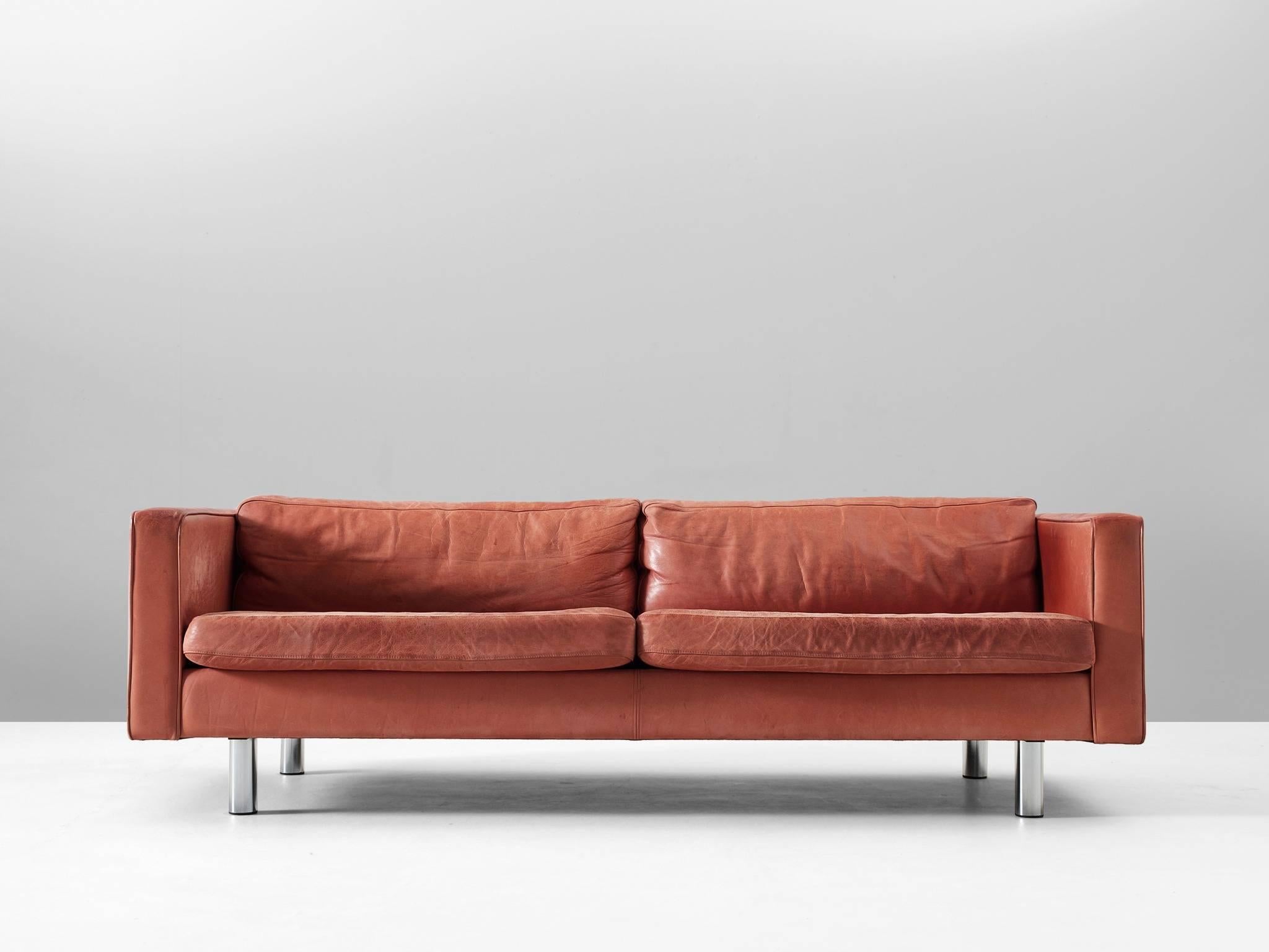 Sofa, in leather and steel by Illums Bolighus, Denmark, 1970s.

Three-seat sofa in red leather. This sturdy sofa has a solid design. Due the loose cushions and quality materials this sofa is highly comfortable. The red leather shows a stunning