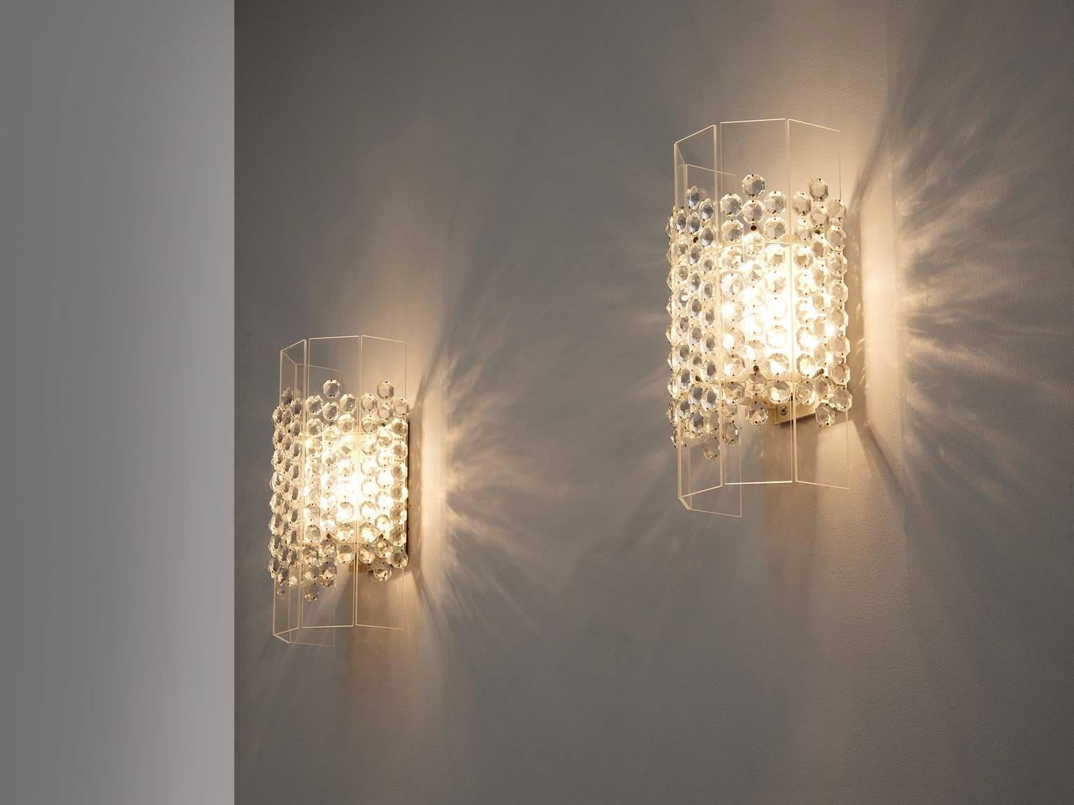 Set of 2 wall lights, Perspex and glass, Germany, 1975. 

A pair of shimmering sconces. These lights have a real simplified design and occur. Due the glass diamonds on the shade they get a stunning appearance. The transparent shade make sure the
