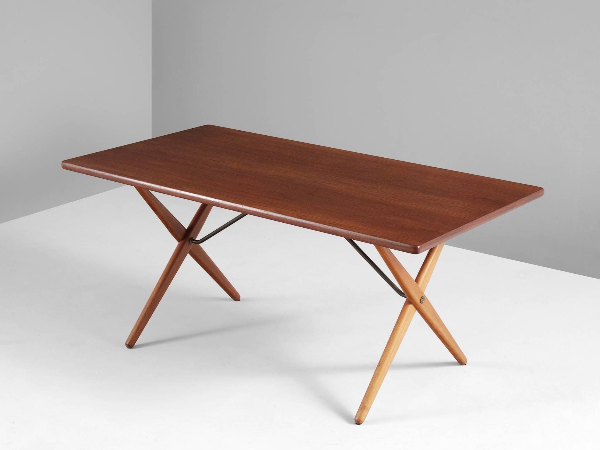 Table model AT-303, in teak, oak and metal, by Hans J. Wegner for Andreas Tuck, Denmark, 1955.

Dining table with elegant X-shaped legs, by Danish Designer Hans Wegner. This table is considered as one of the best known designs from Wenger. From a