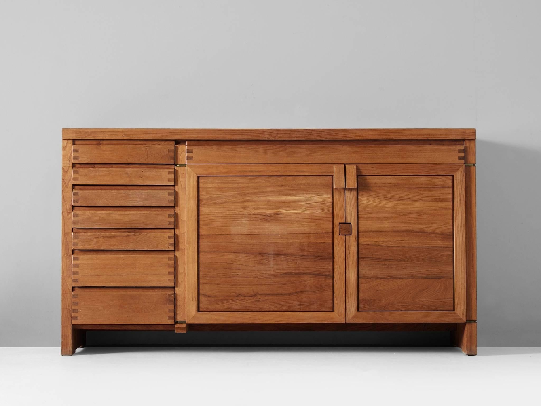 Sideboard model R13, in elm, by Pierre Chapo, France 1960s.

This well crafted credenza shows the basic design and sincere construction details, which characterize Chapo's work. The frontal view is interesting, due to the well proportioned doors