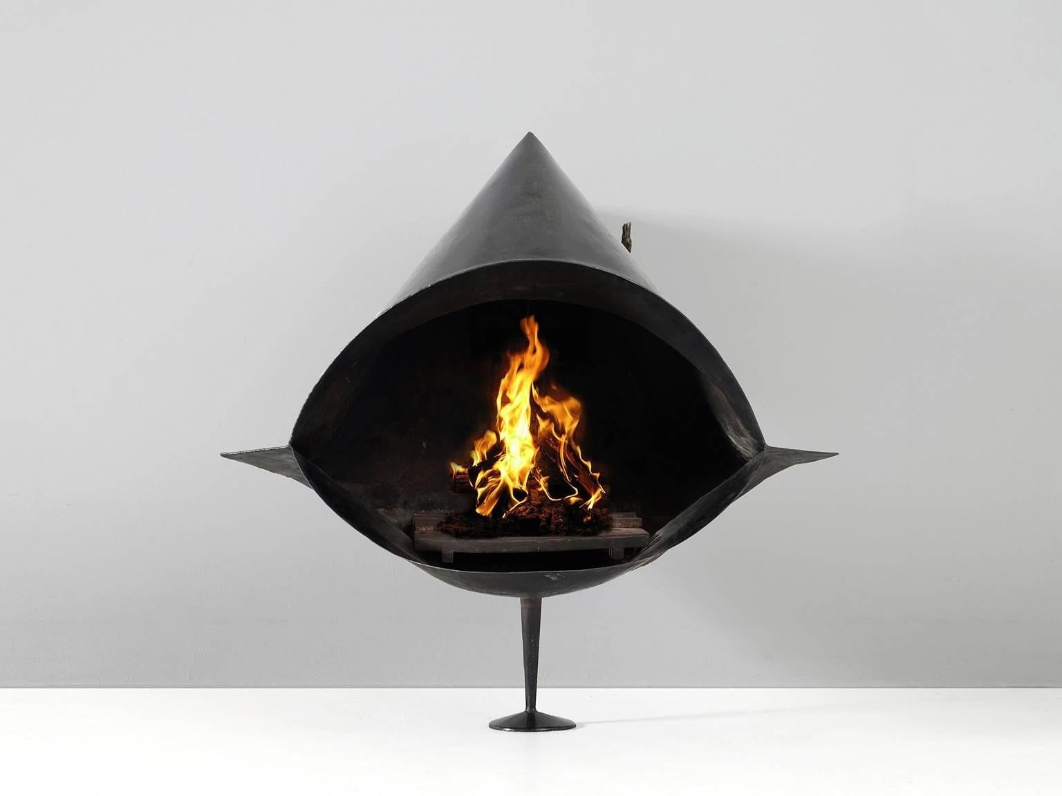 Fire place, steel, European, 1970s. 

Wall-mounted fire place in black coated steel. Cone shaped body with large oval firepit. The design is divided in different levels, which emphasize the three-dimensional appearance. The air supply is