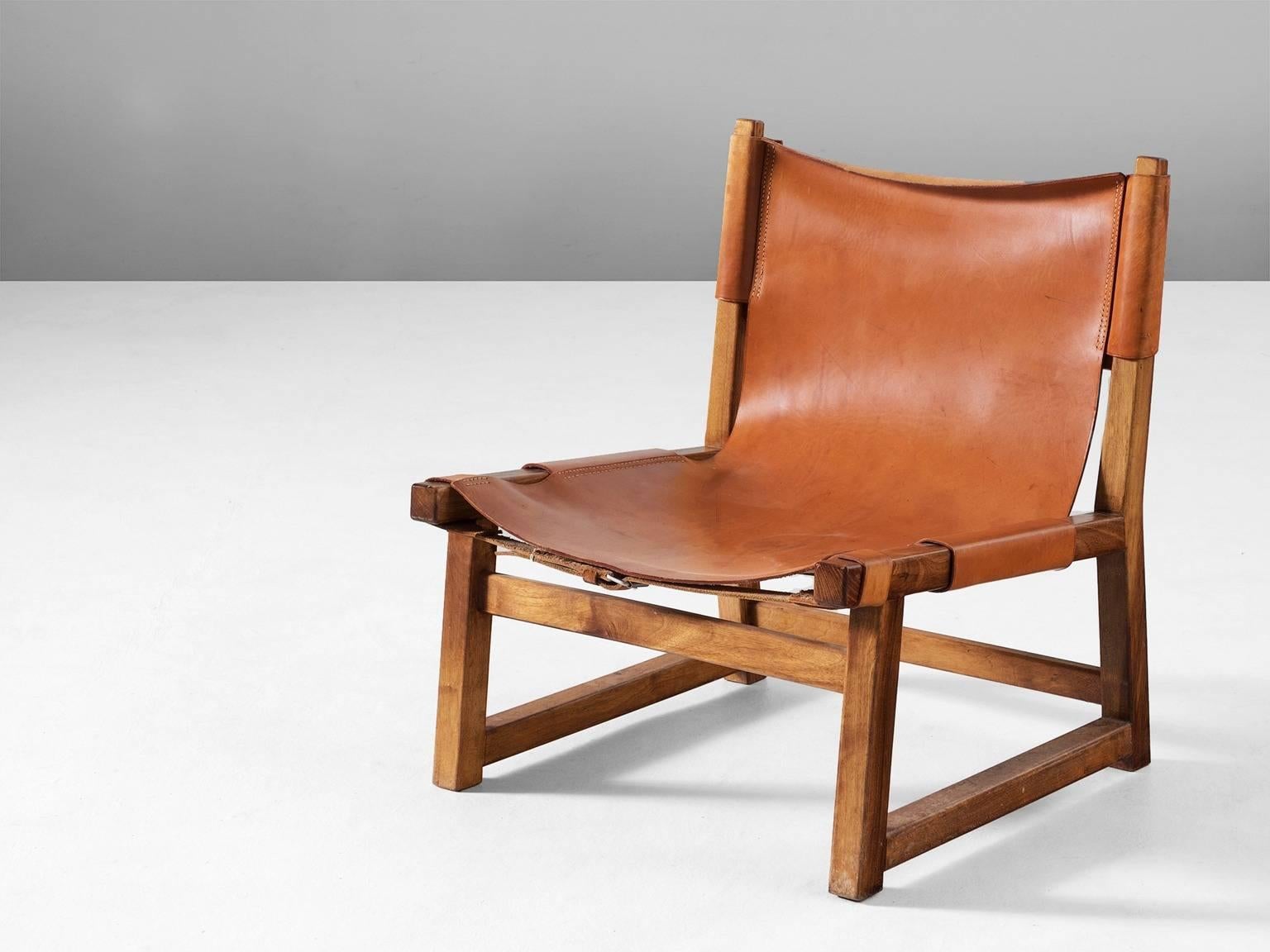 Hunting chair, wood and leather, Scandinavia, 1950s. 

Sturdy chair with a frame of solid oak. The seating is from cognac colored saddle leather with nice contrasting stitching. The natural leather shows a beautiful patina which gives this chair