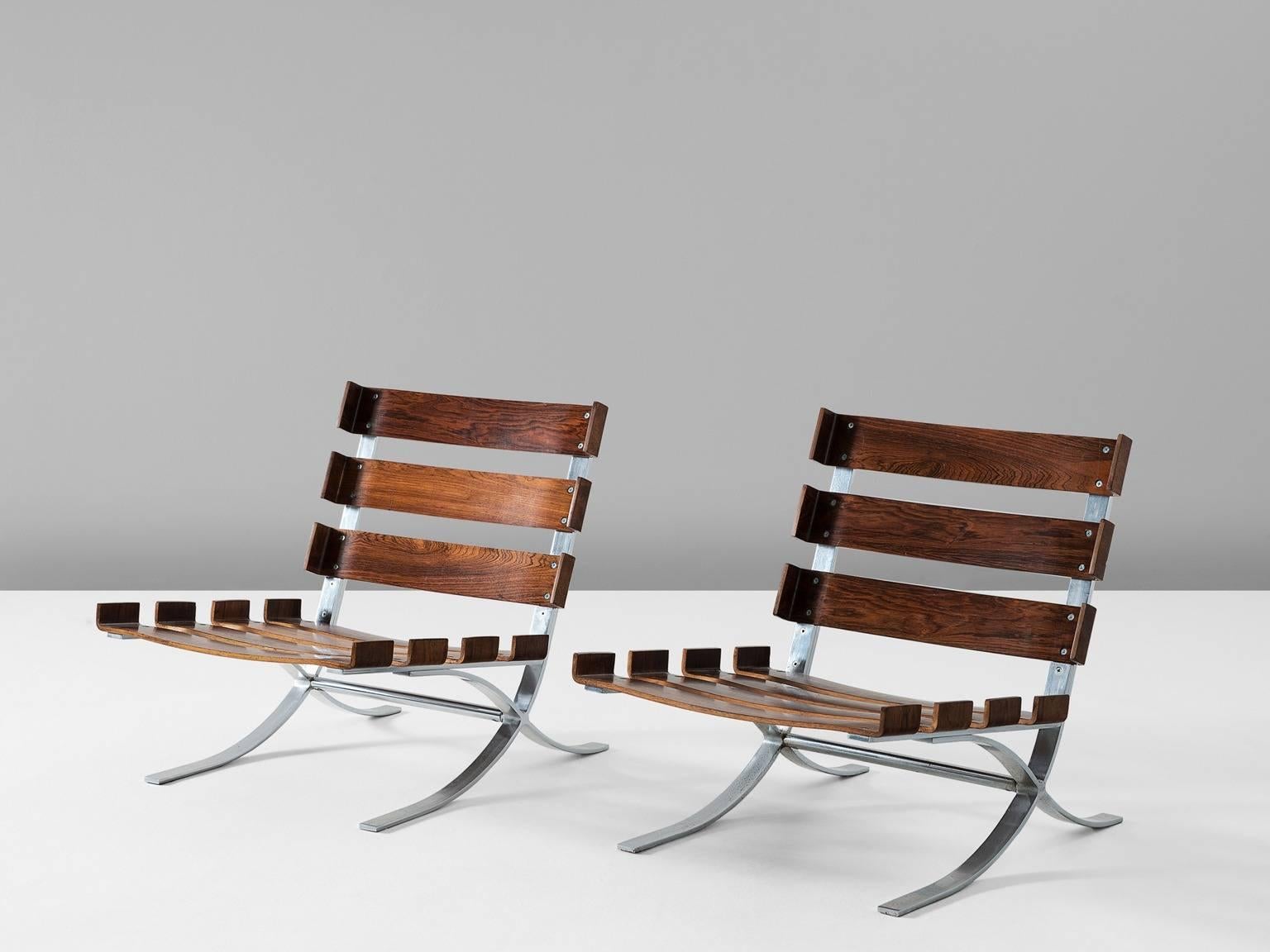 Easy chairs, in steel and rosewood, Europe, 1970s.

A pair of X-shaped lounge chairs. The very well formed metal frames hold a sturdy rosewood slat seating and back. These desirable chairs can be placed in the same range of style as the famous,