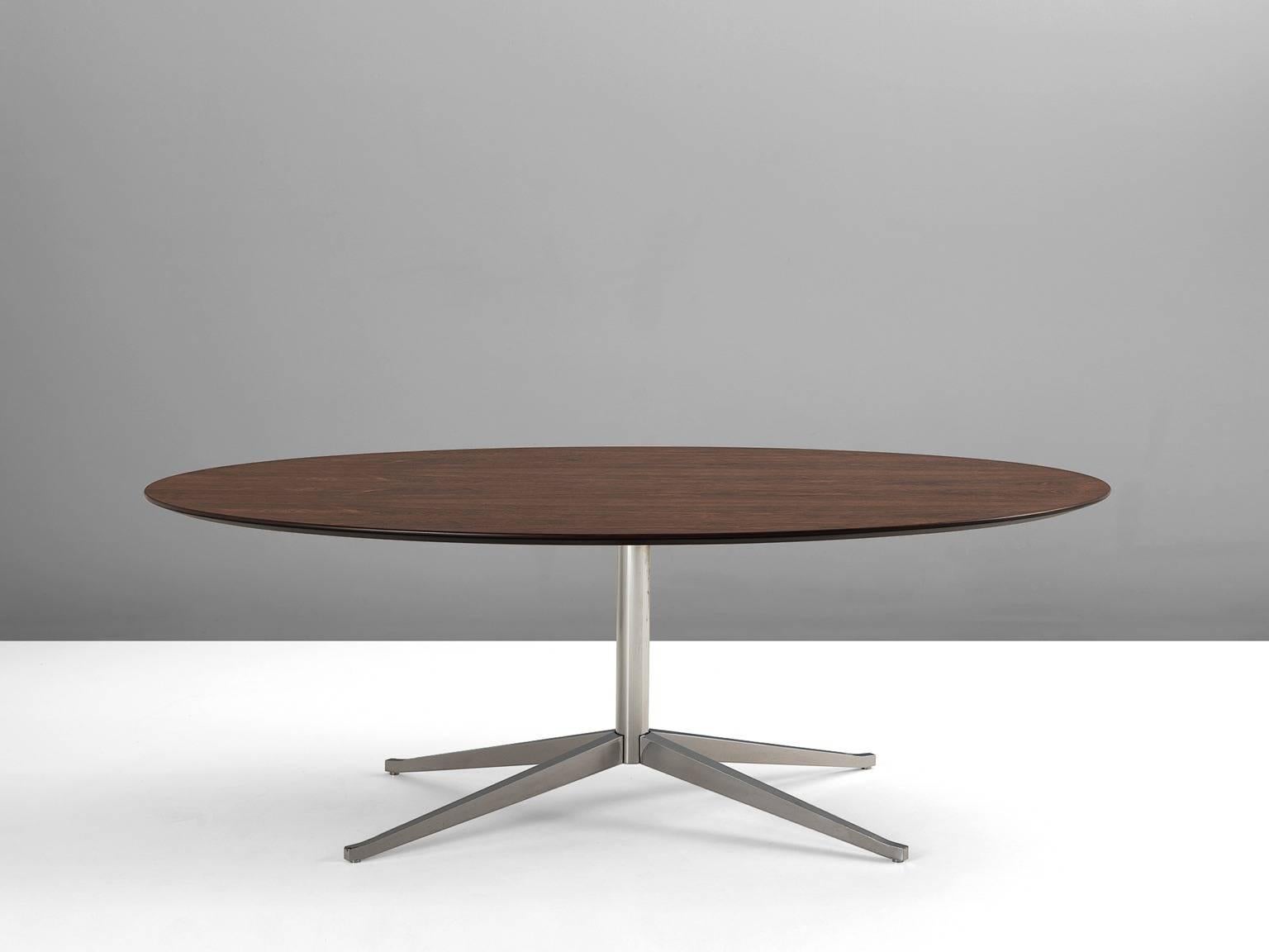Dining table, in metal and rosewood, by Florence Knoll for Knoll International, United States, 1960s. 

Large oval dining table by Florence Knoll. This table consist of a chromed metal base with one column and four legs. The legs combine into an