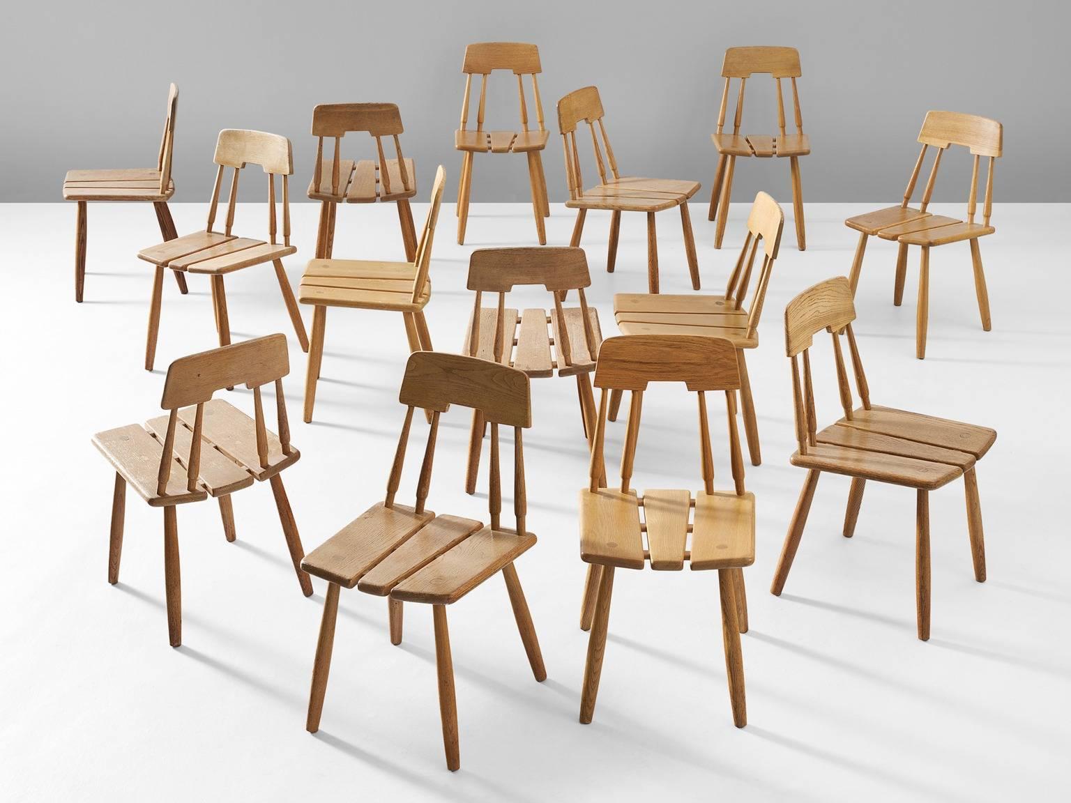 Set of 14 dining chairs, in oak, Finland, 1950s.

Dining chairs in the style of Ilmari Tapiovaara. 14 chairs in solid oak with elegant details in the back. The seating consist of three parts, with nice visible wood-joints of the four legs. Four