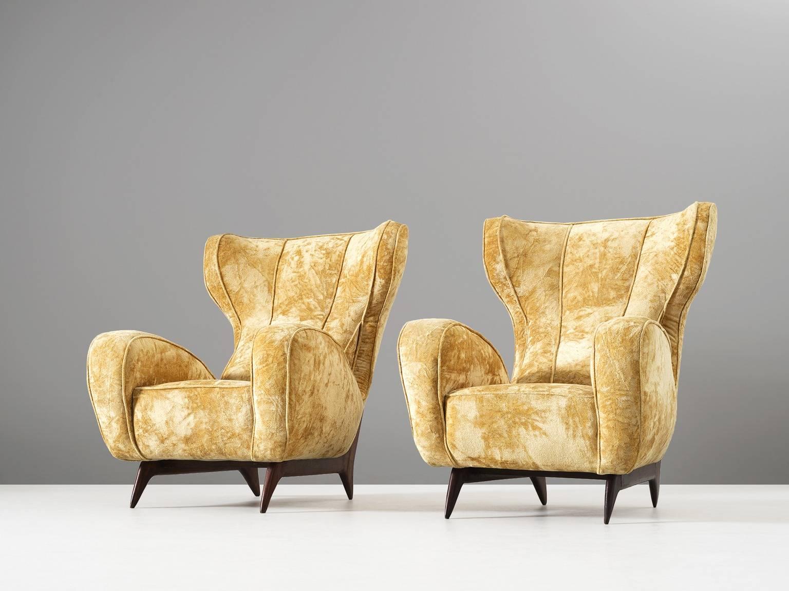 Pair of lounge chairs, in fabric and wood, attributed to Carlo Graffi, Italy, 1950s. 

Set of two large and comfortable lounge chairs. These reupholstered chairs have a very present character. The back is high with characteristic 'ears', which run