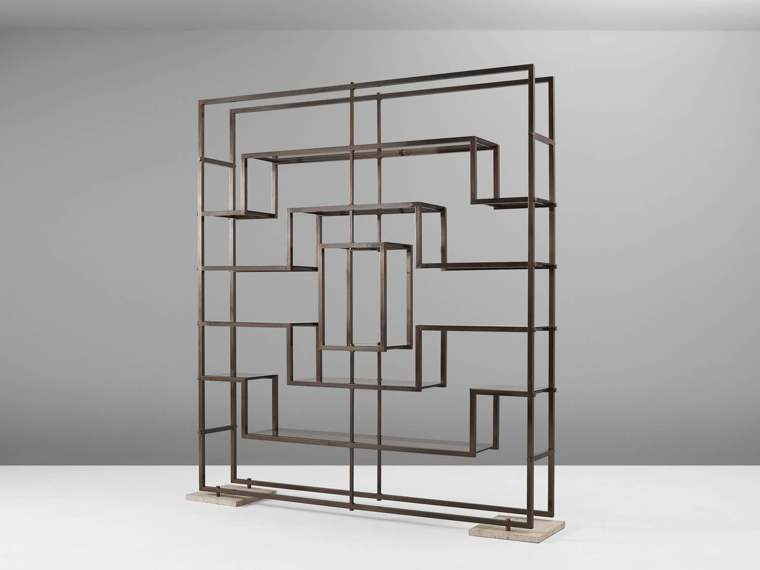 Etagere, in brass and glass, by Romeo Rega, Italy, 1970s.

Large wall console by Italian designer Romeo Rega. This graphical room divider shows beautiful symmetric lines. The horizontal lines are equipped with smoked glass shelves, which makes