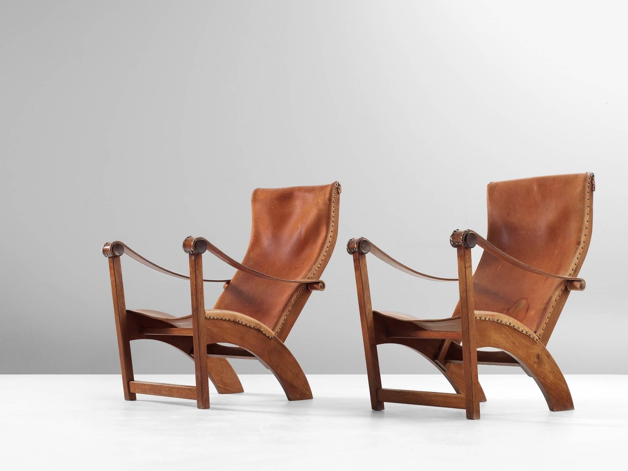 Lounge chairs model 'Københavnerstolen', in mahogany and leather, by Mogens Voltelen for Niels Vodder, Denmark 1936. 

Set of two stunning Copenhagen chairs by Mogens Voltelen. These chairs shows beautiful lines as seen on the arched legs on the