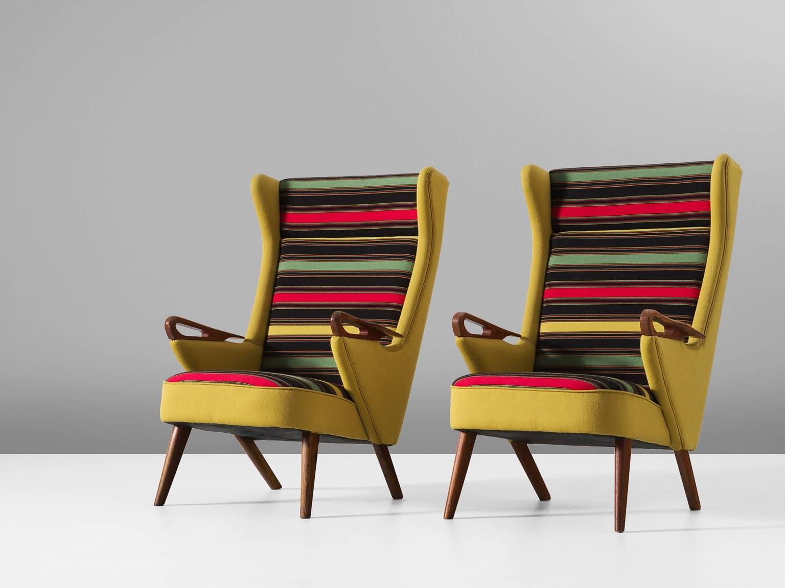 Pair of lounge chairs, in teak and fabric, Denmark, 1960s.

Colorful pair of reupholstered Danish armchairs. These elegant chairs are upholstered in yellow fabric on the outside and striped multicolor on the inside. The high back shows a nice