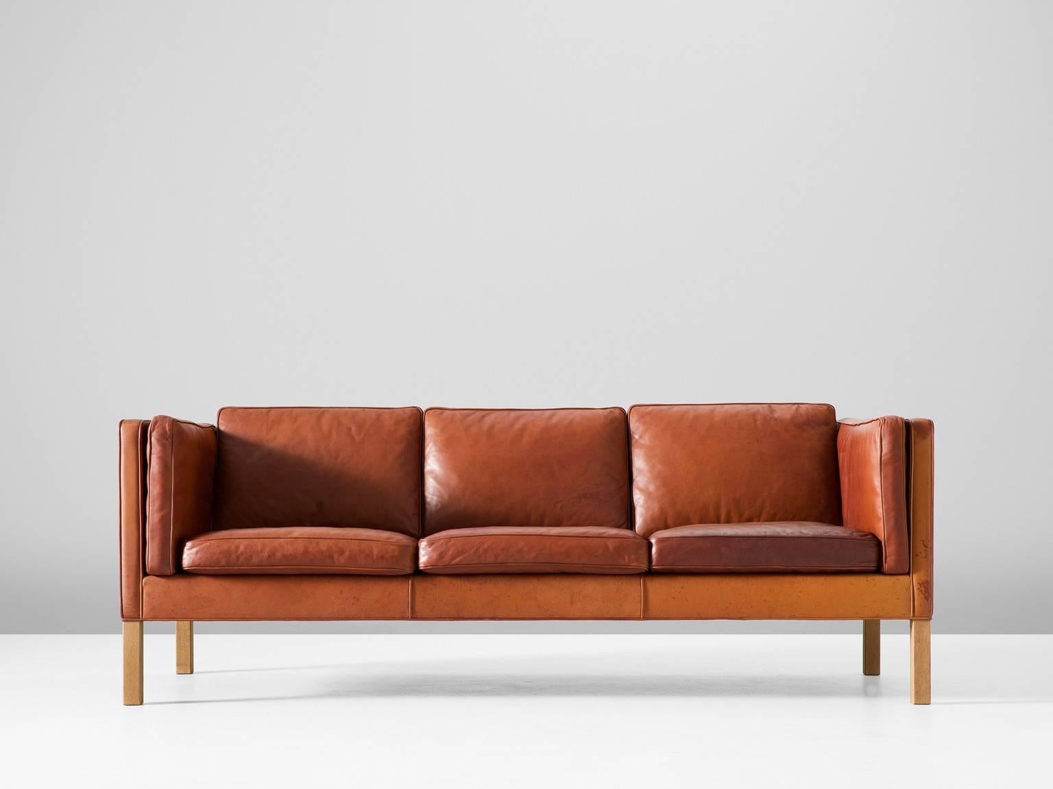 Sofa model 2443, leather and oak, by Børge Mogensen for Fredericia Stolefabrik, Denmark, 1960s. 

This design comes from the 1960s and has wonderful shapes and comfort. The three-seater sofa comes with loose cushions in seating, back and sides.